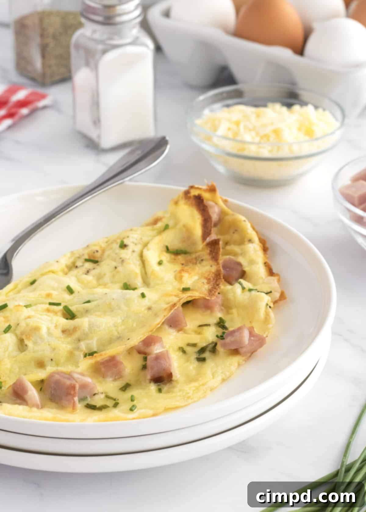The Ultimate Omelet Guide 8 A perfectly cooked omelet with a variety of fillings, ready to be served.