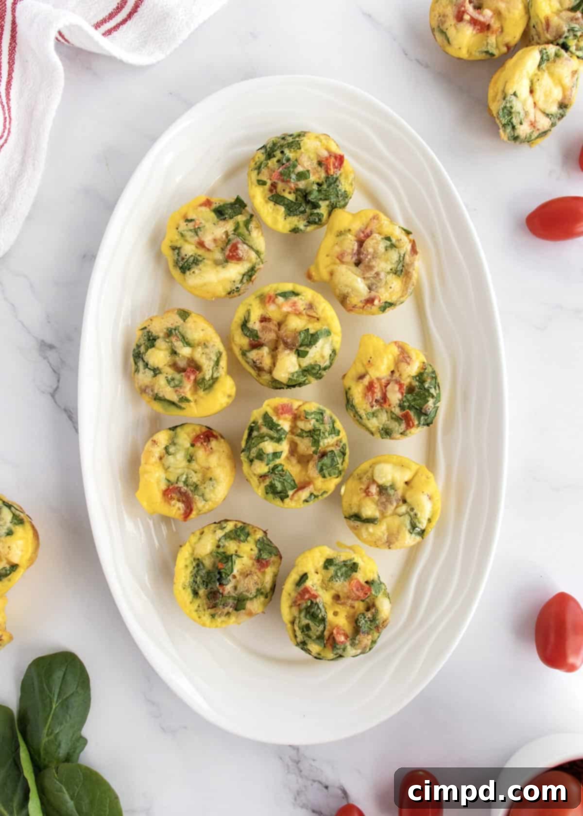 Savory Bacon, Spinach and Tomato Egg Bites 6 Individual Bacon Spinach and Tomato Egg Bites on a serving tray