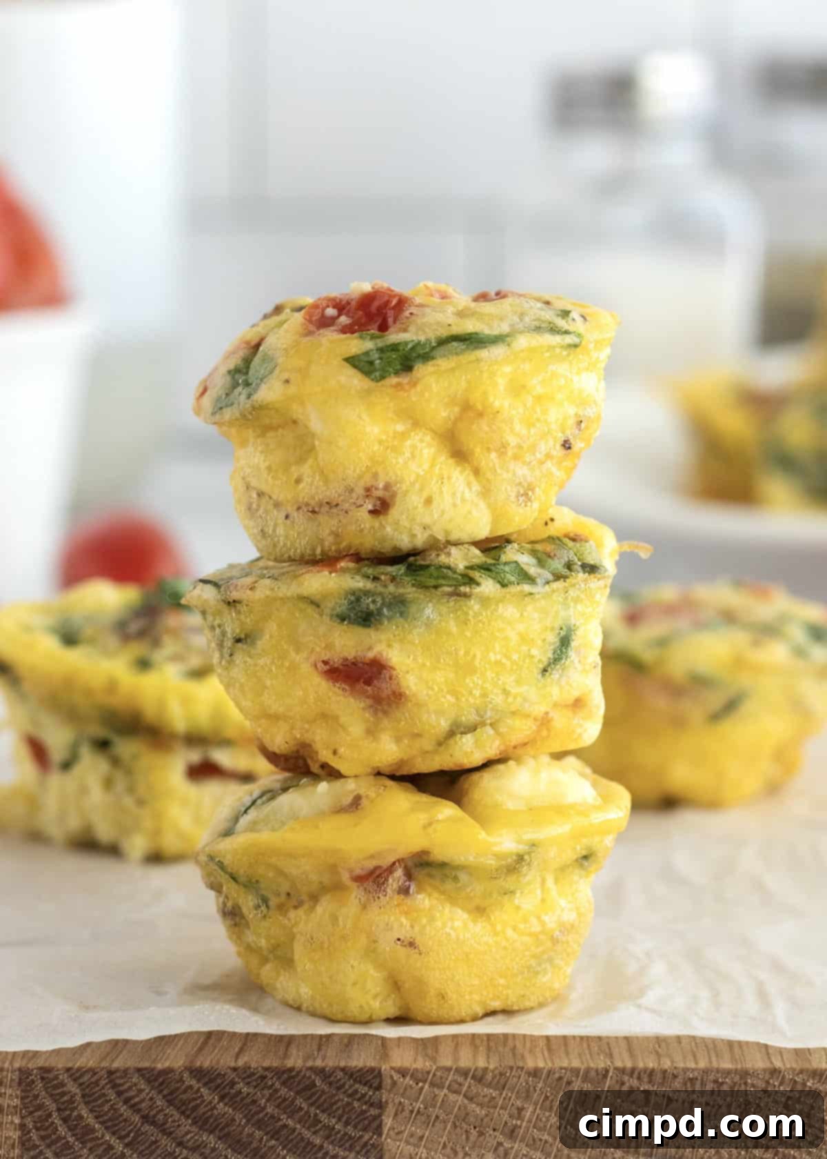 Savory Bacon, Spinach and Tomato Egg Bites 7 Multiple Bacon Spinach and Tomato Egg Bites arranged neatly on a plate