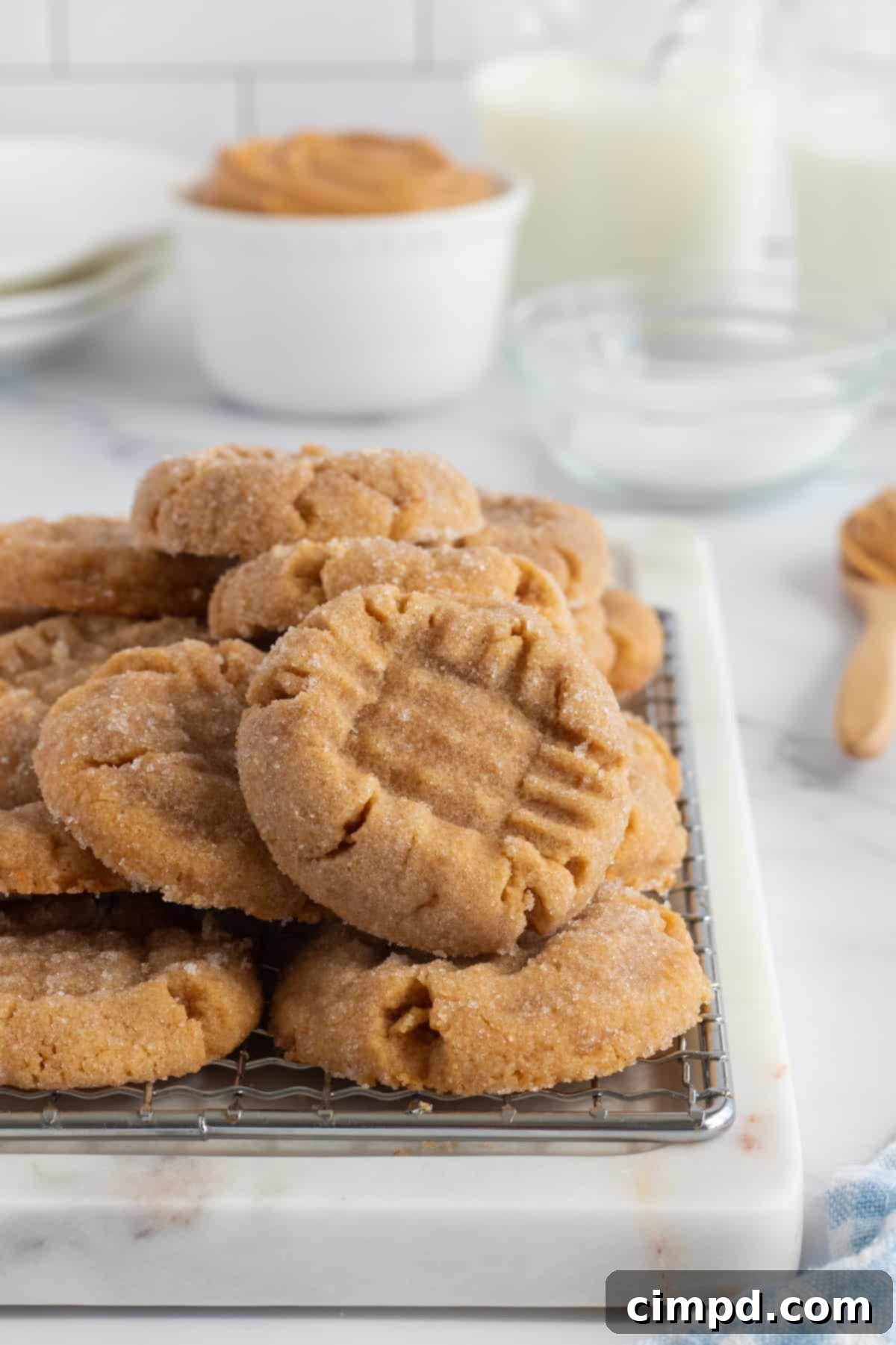 Effortless 4 Ingredient Flourless Peanut Butter Cookies 6 Finished 4-Ingredient Flourless Peanut Butter Cookies stacked on a plate