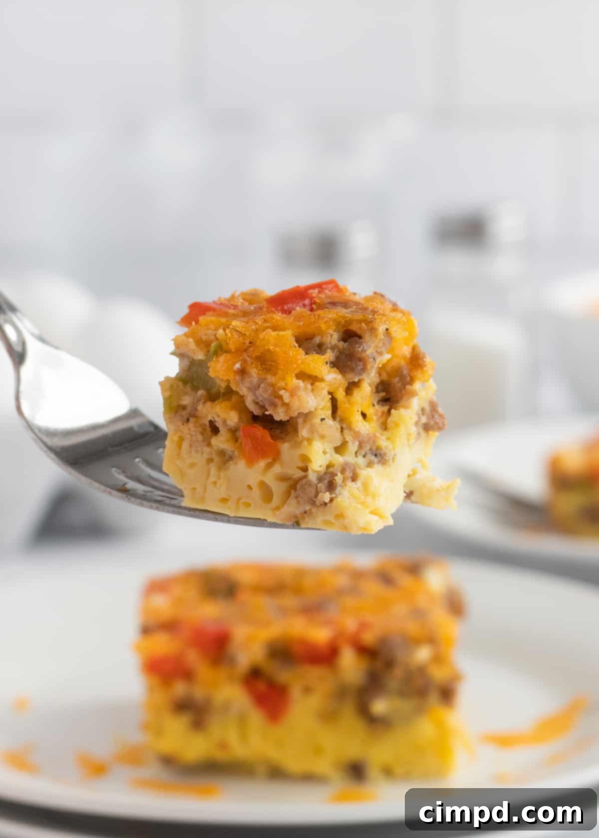 Close-up of baked Sausage Egg Casserole with melted cheese and bell peppers