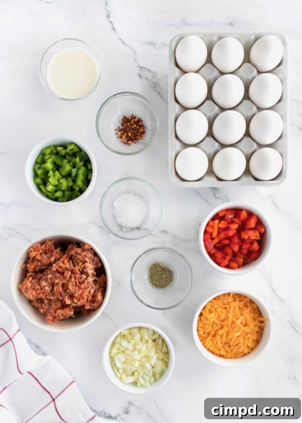 Fresh ingredients for sausage egg casserole laid out on a table