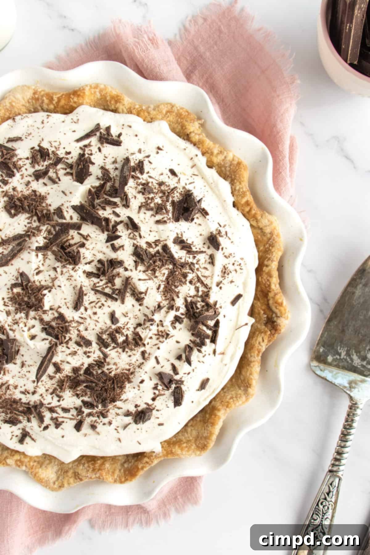 Cool, creamy, and decadent Chocolate Cream Pie with a flaky crust and silky chocolate filling, garnished with chocolate shavings.