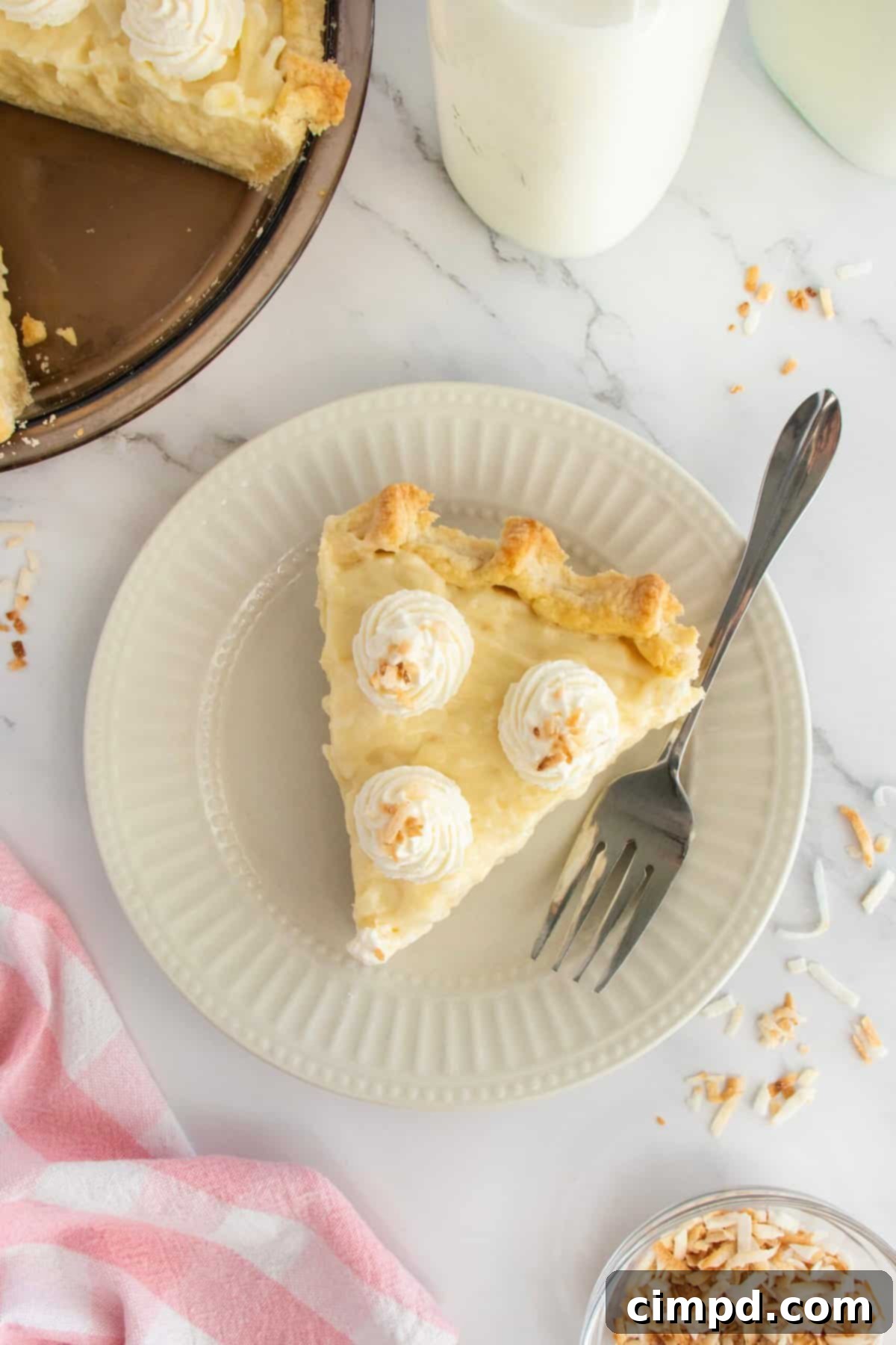 A beautifully presented whole Coconut Cream Pie, ready to be cut into slices