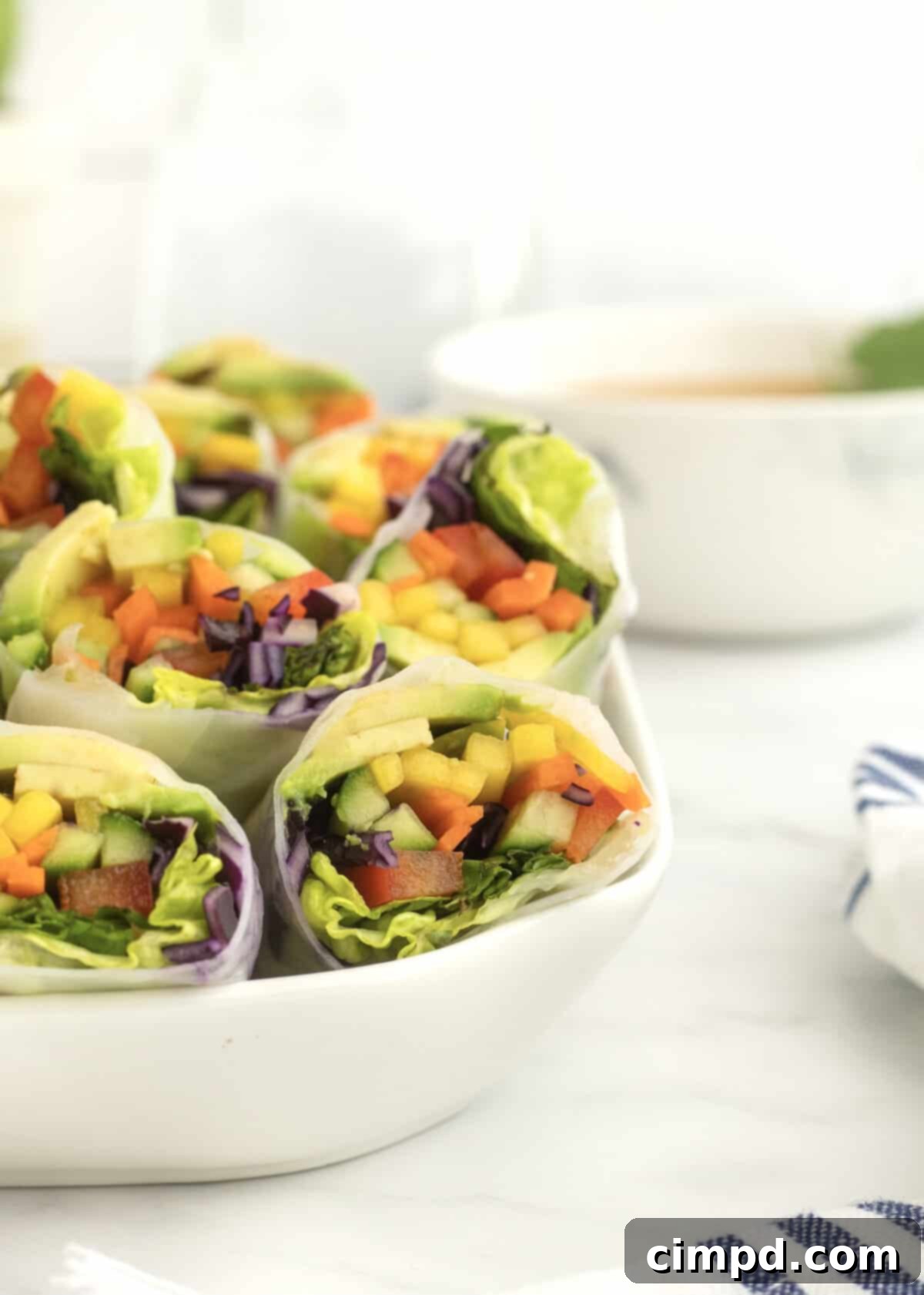 Refreshing Summer Wraps 9 A stunning overhead shot of multiple Fresh Summer Rolls and a bowl of peanut sauce.