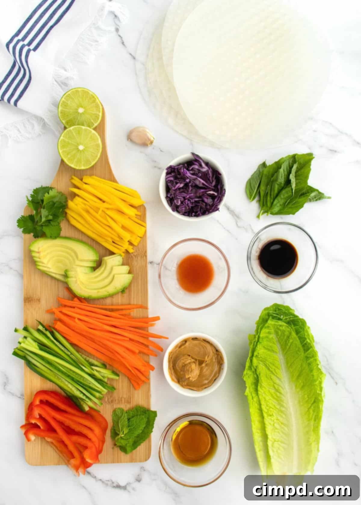Refreshing Summer Wraps 5 A colorful array of fresh summer roll ingredients laid out on a cutting board, ready for assembly.