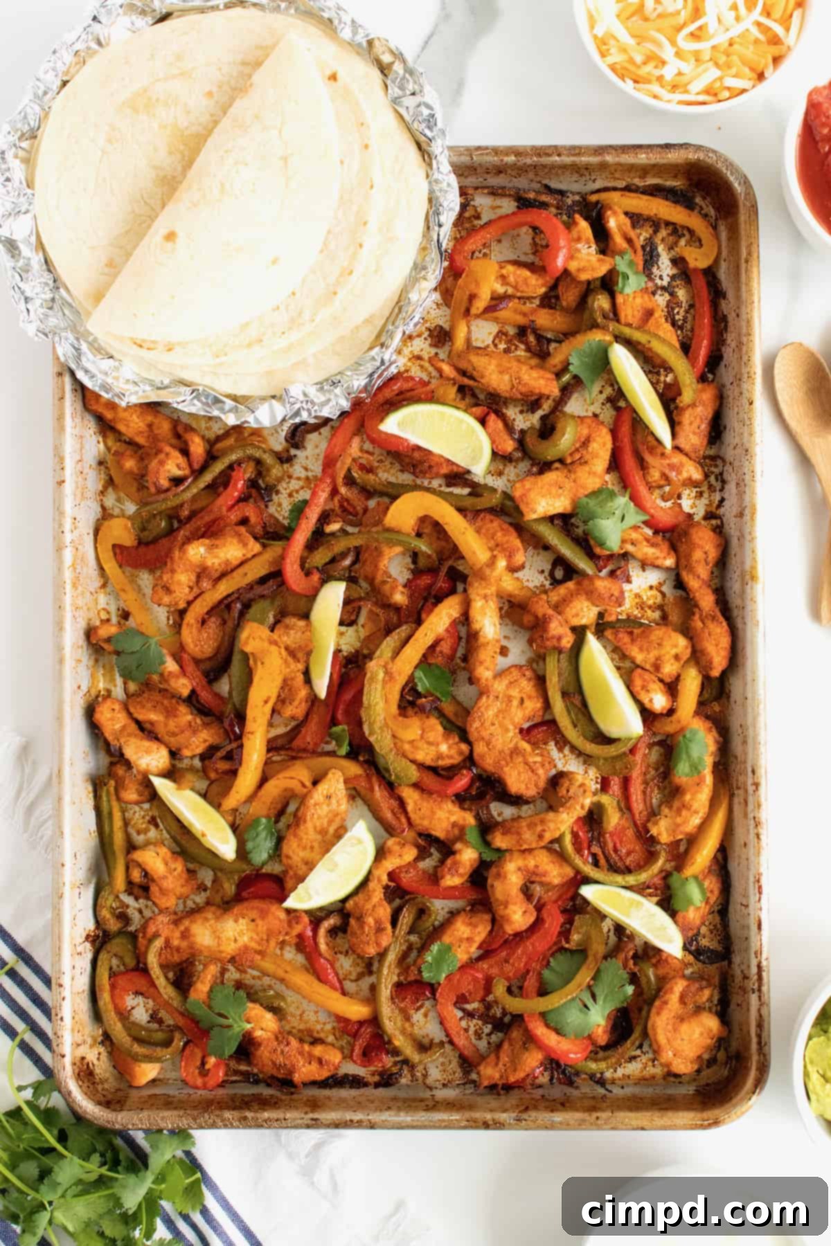 Colorful Sheet Pan Chicken Fajitas with sliced chicken, bell peppers, and onions, ready for serving.