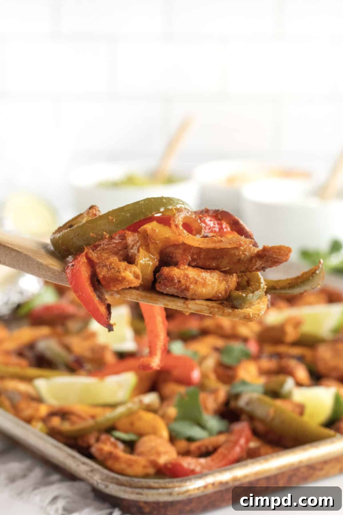 Close-up of freshly cooked Sheet Pan Chicken Fajitas, showing tender chicken strips and caramelized vegetables.