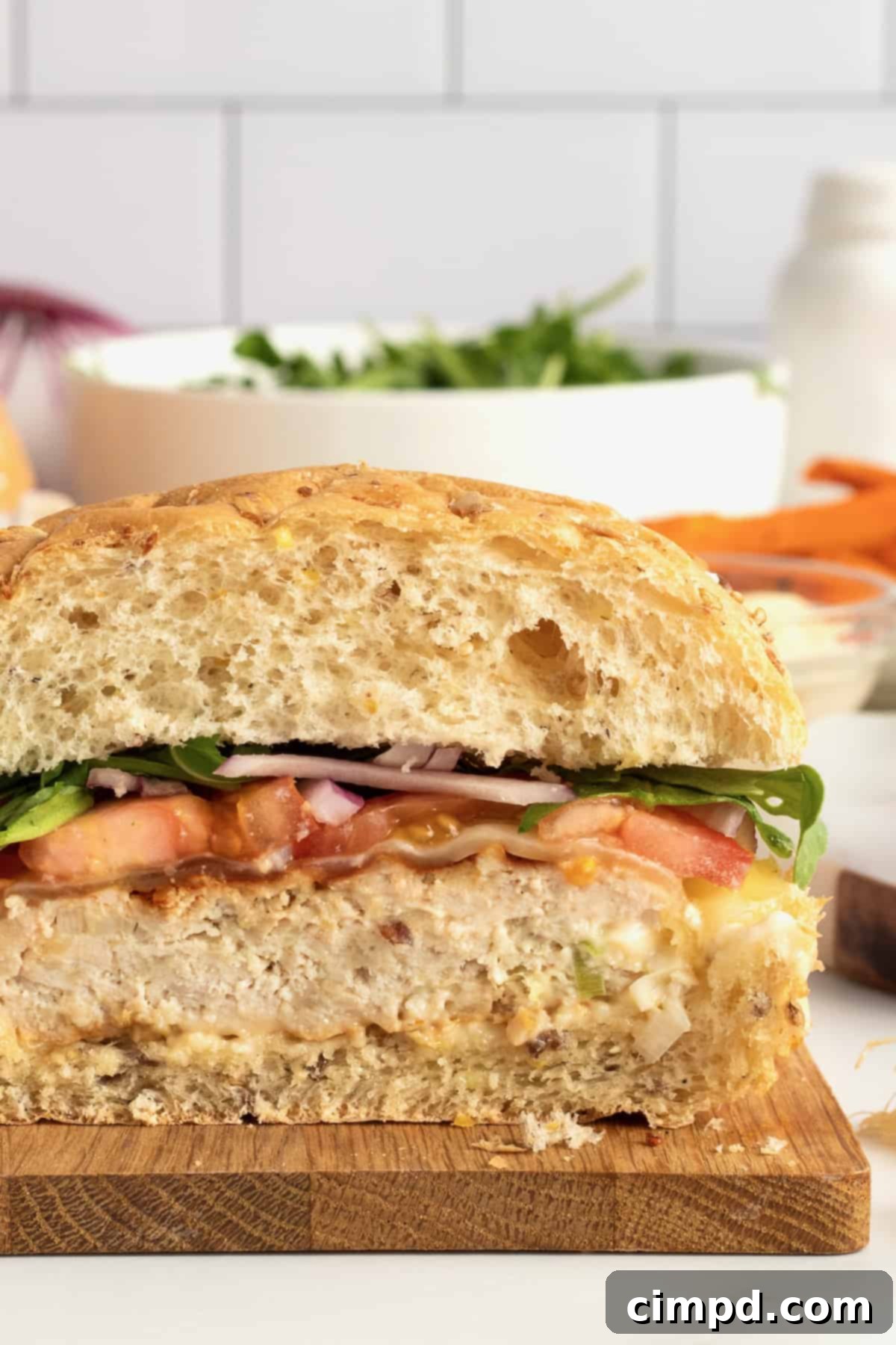 Fire-Kissed Turkey Burgers 3 Close-up of two grilled turkey burgers, showcasing their golden-brown exterior and delicious fillings.