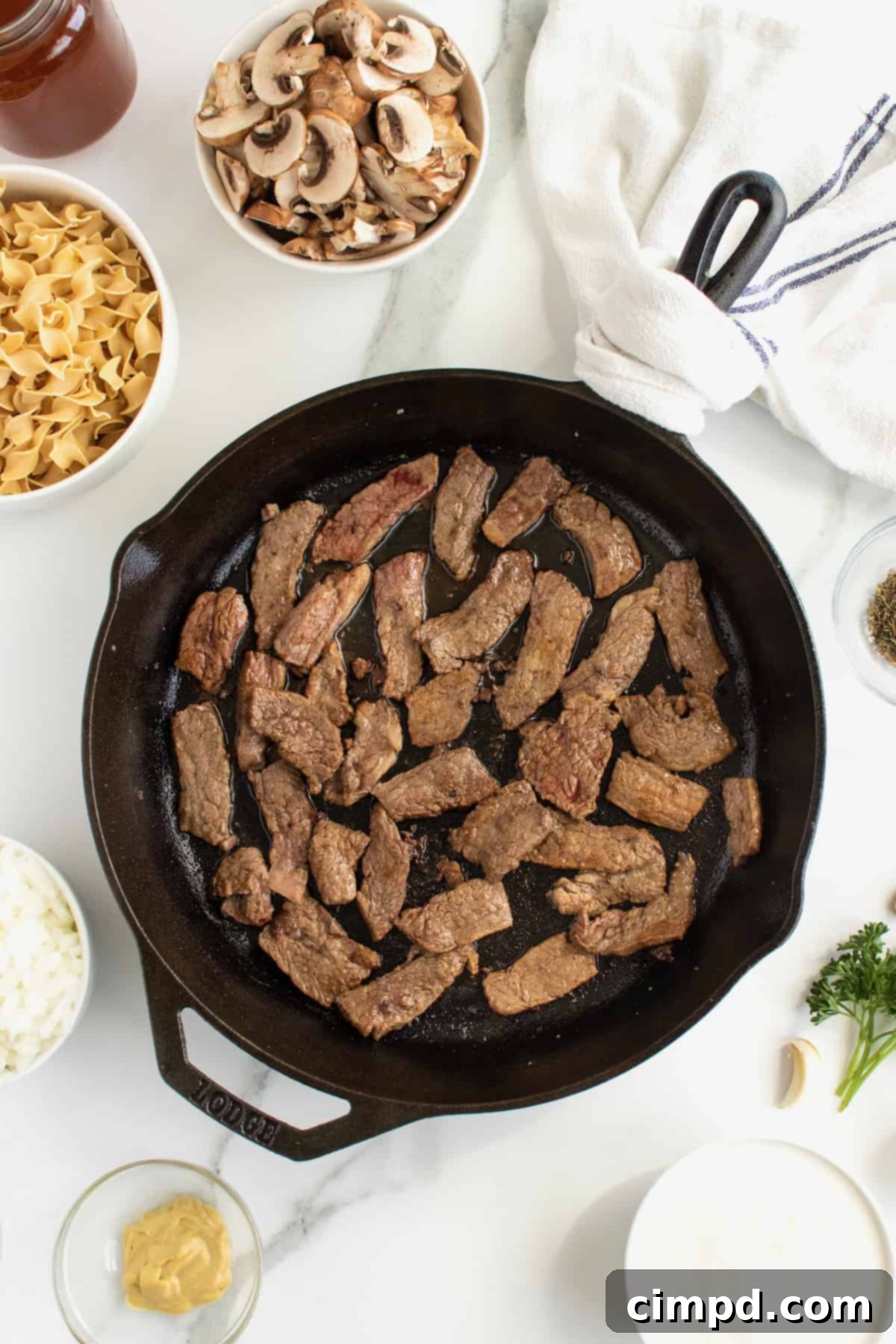 Simple Beef Stroganoff 5 Searing beef in a hot cast iron skillet for Stroganoff