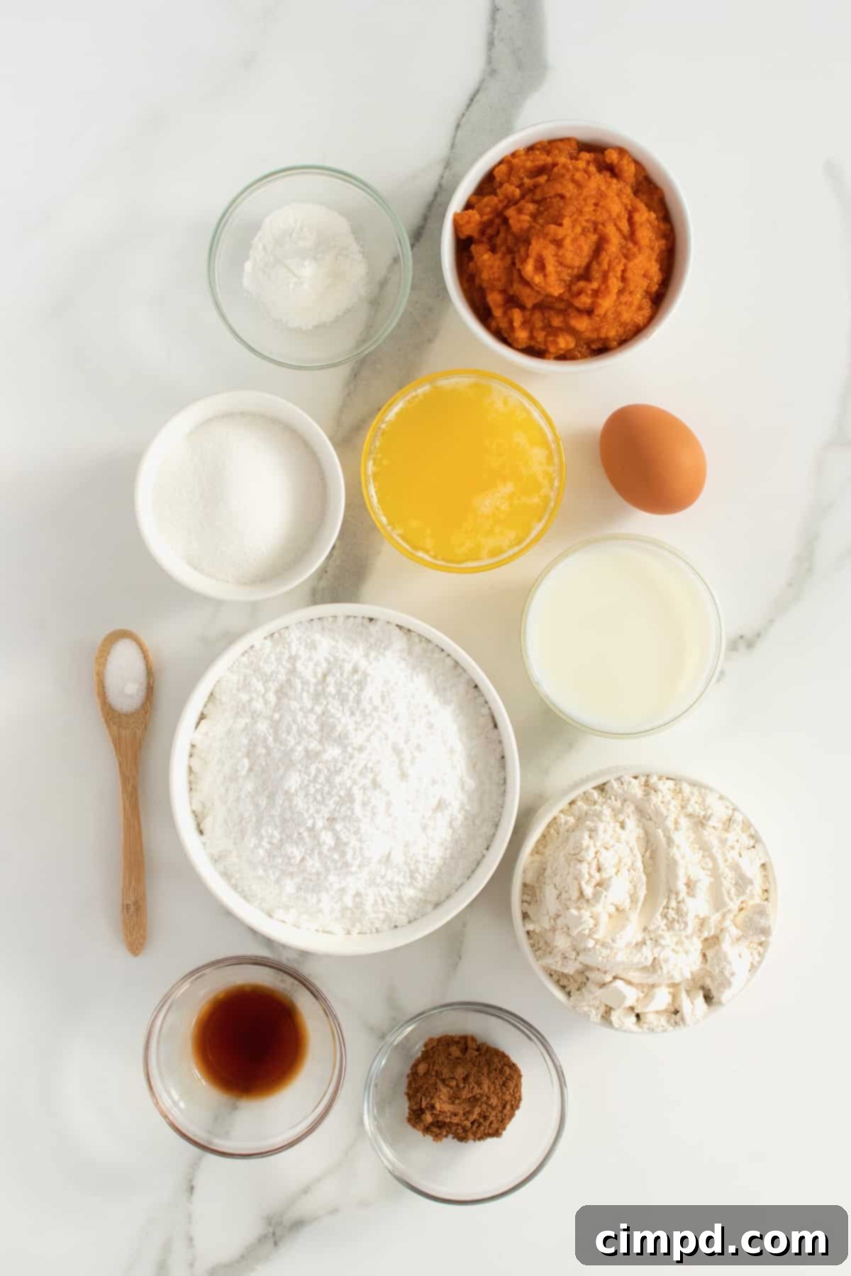 Baked Pumpkin Poppers 5 A flat lay of all the fresh ingredients needed to make Baked Pumpkin Fritter Bites, neatly arranged on a rustic wooden surface.
