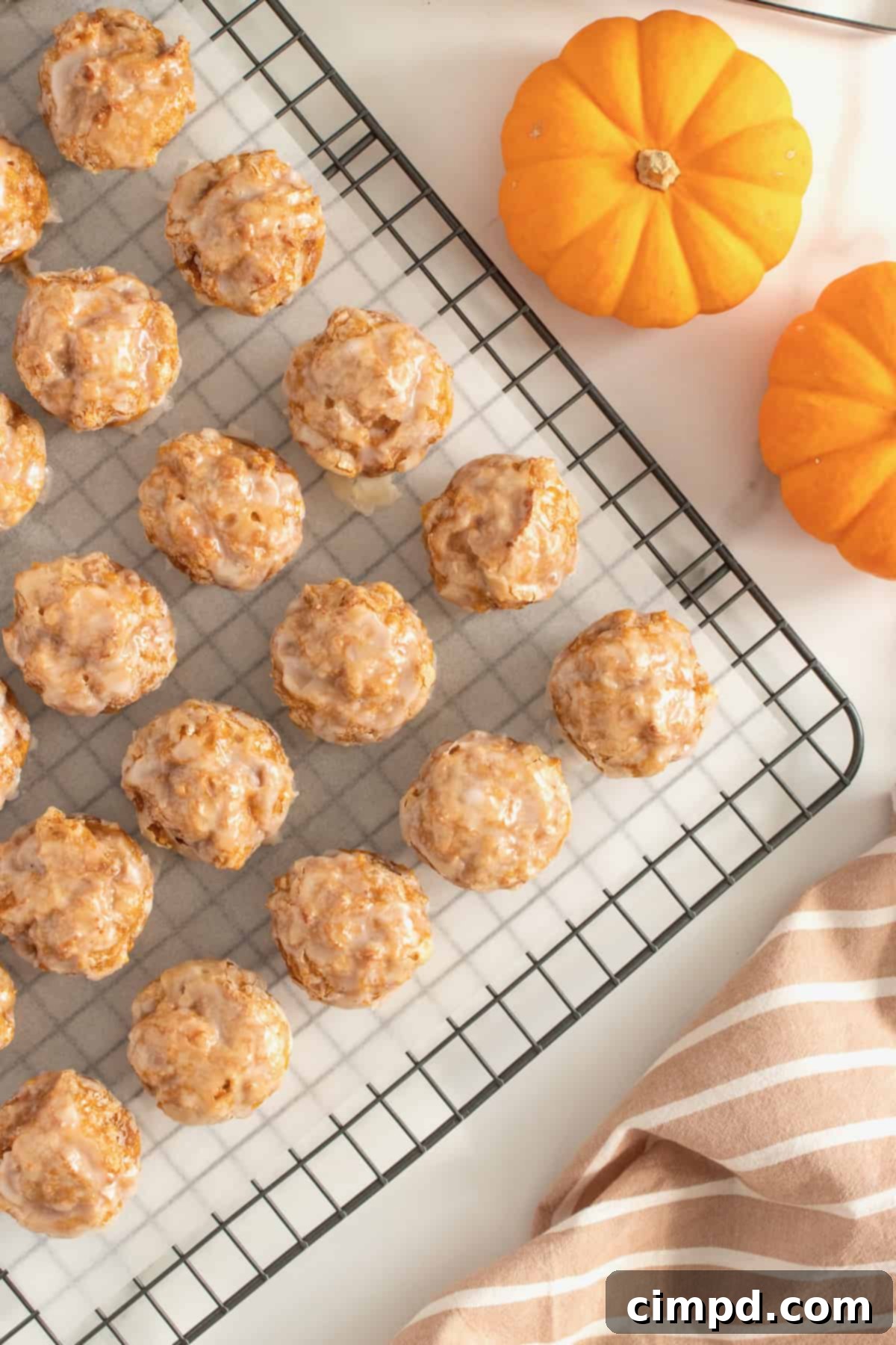 Baked Pumpkin Poppers 9 A beautifully composed shot of baked pumpkin fritter bites on a serving platter, inviting enjoyment.