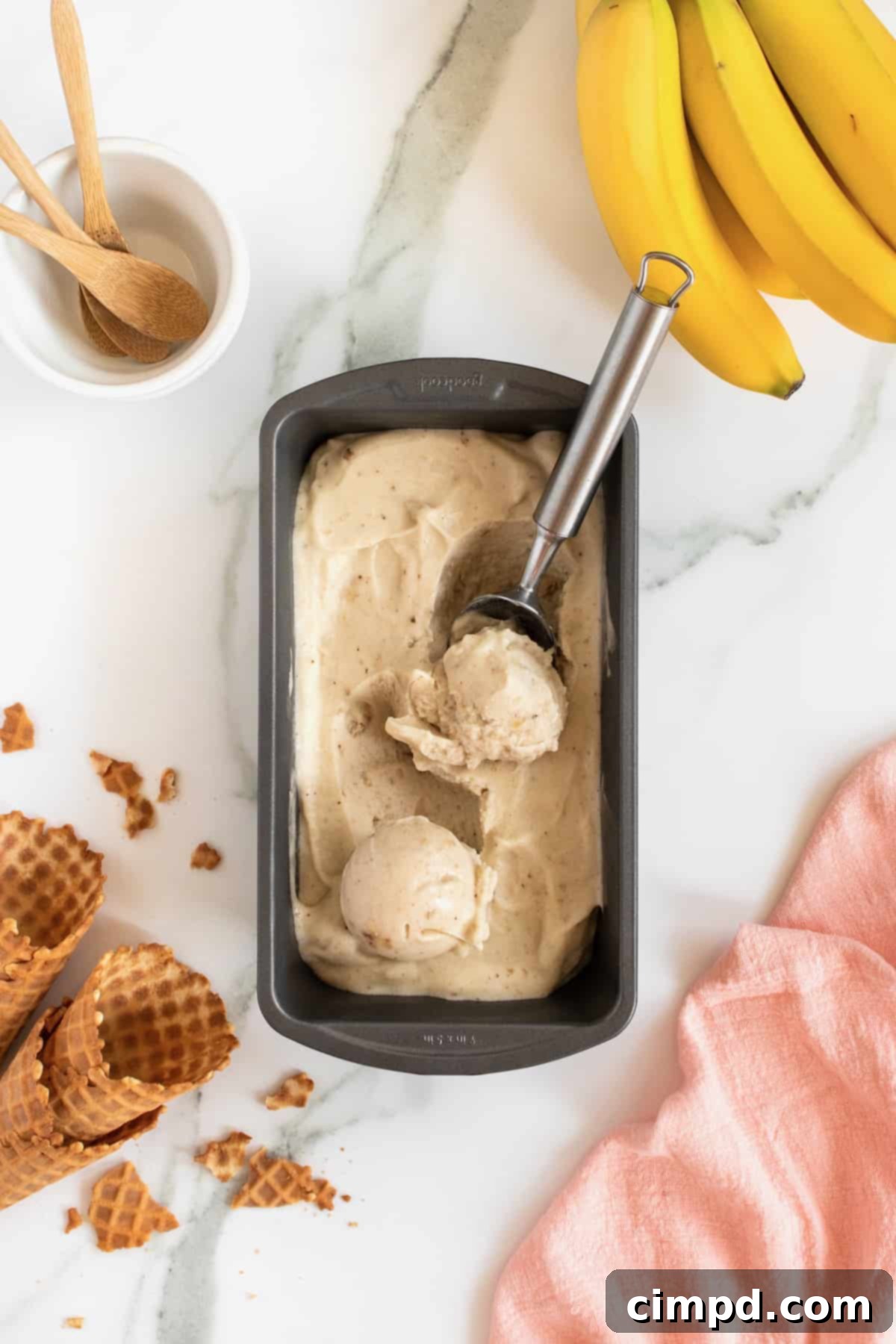 Pure Banana Bliss 5 A cone filled with creamy One-Ingredient Banana Ice Cream, ready to be enjoyed, by The BakerMama