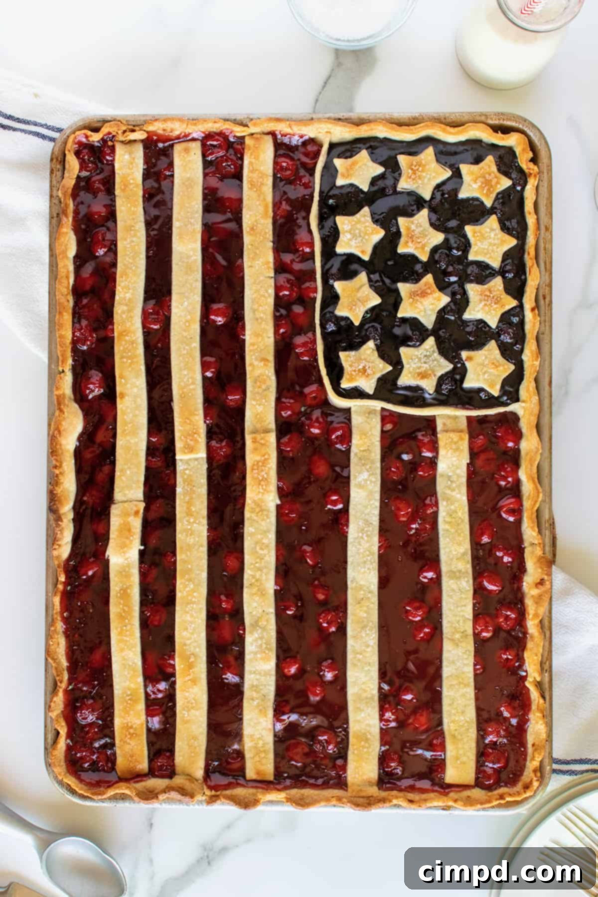 Stars and Stripes Pie 8 A freshly baked American Flag Pie, still on the baking sheet, with a slice already removed, showing the juicy fruit filling.
