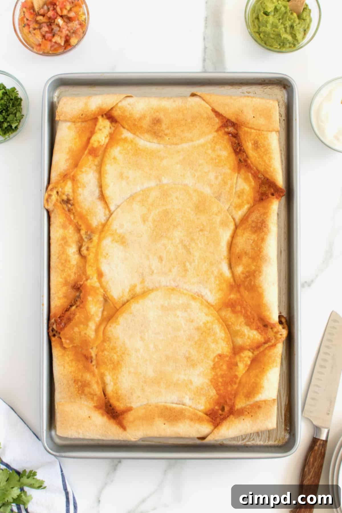 Sheet Pan Quesadilla being pressed by a second sheet pan