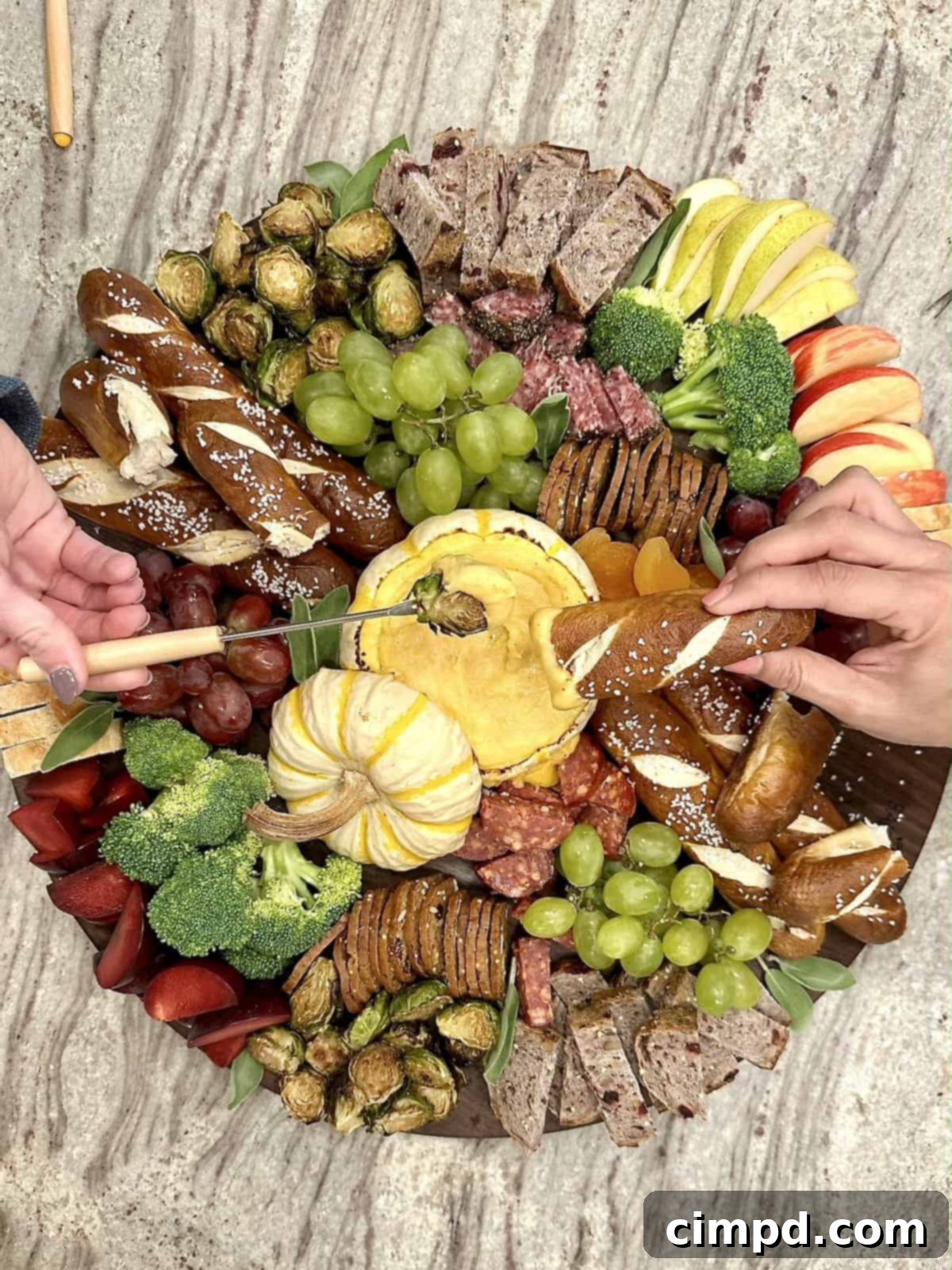 Another beautiful shot of the Fall Fondue Board with a focus on the delicious variety of dippers and the warm, inviting fondue.