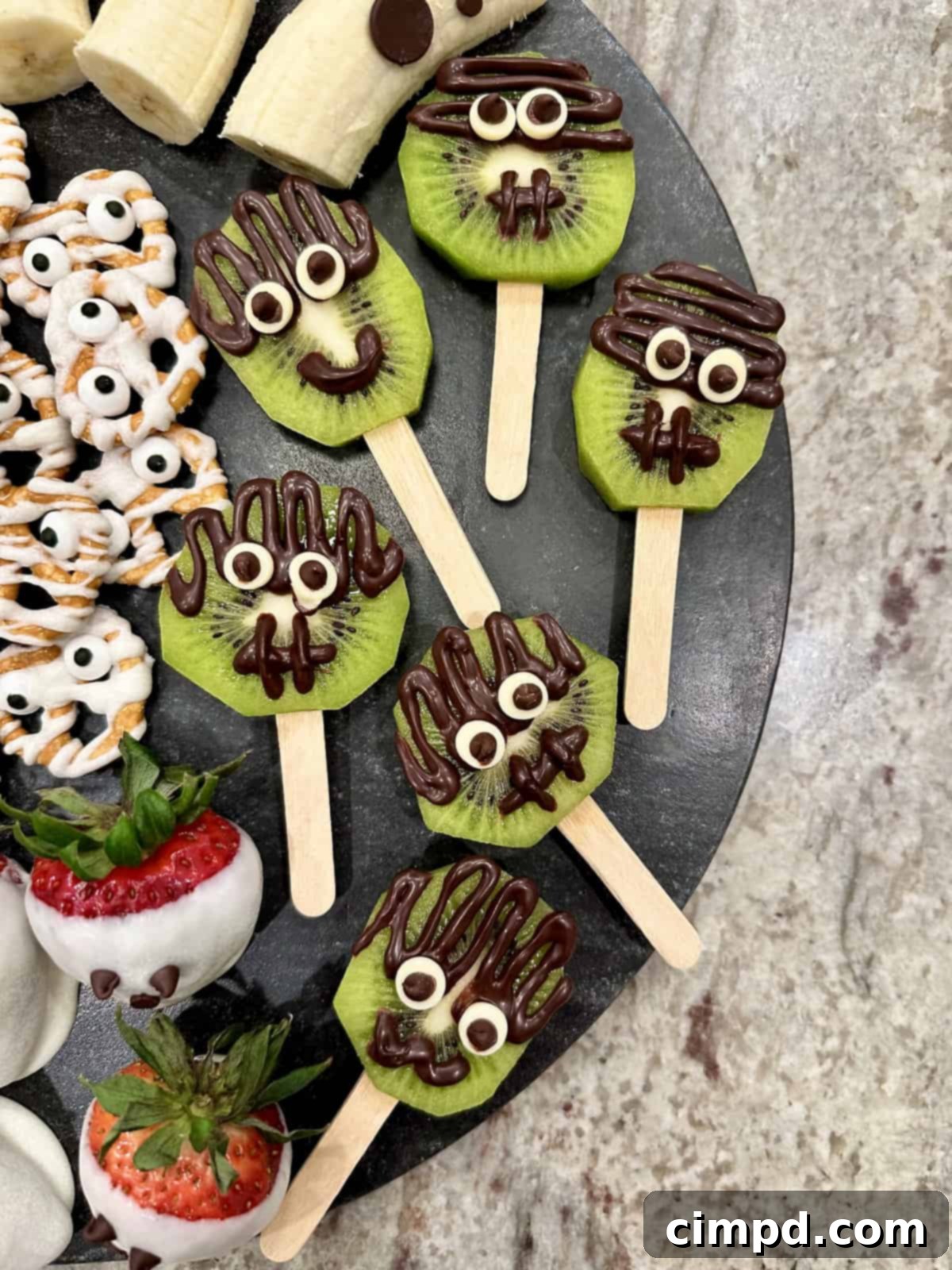 5 Spooktacularly Cute Halloween Goodies 7 Spooky Cute Halloween Treats by The BakerMama Frankenstein Kiwi Pops