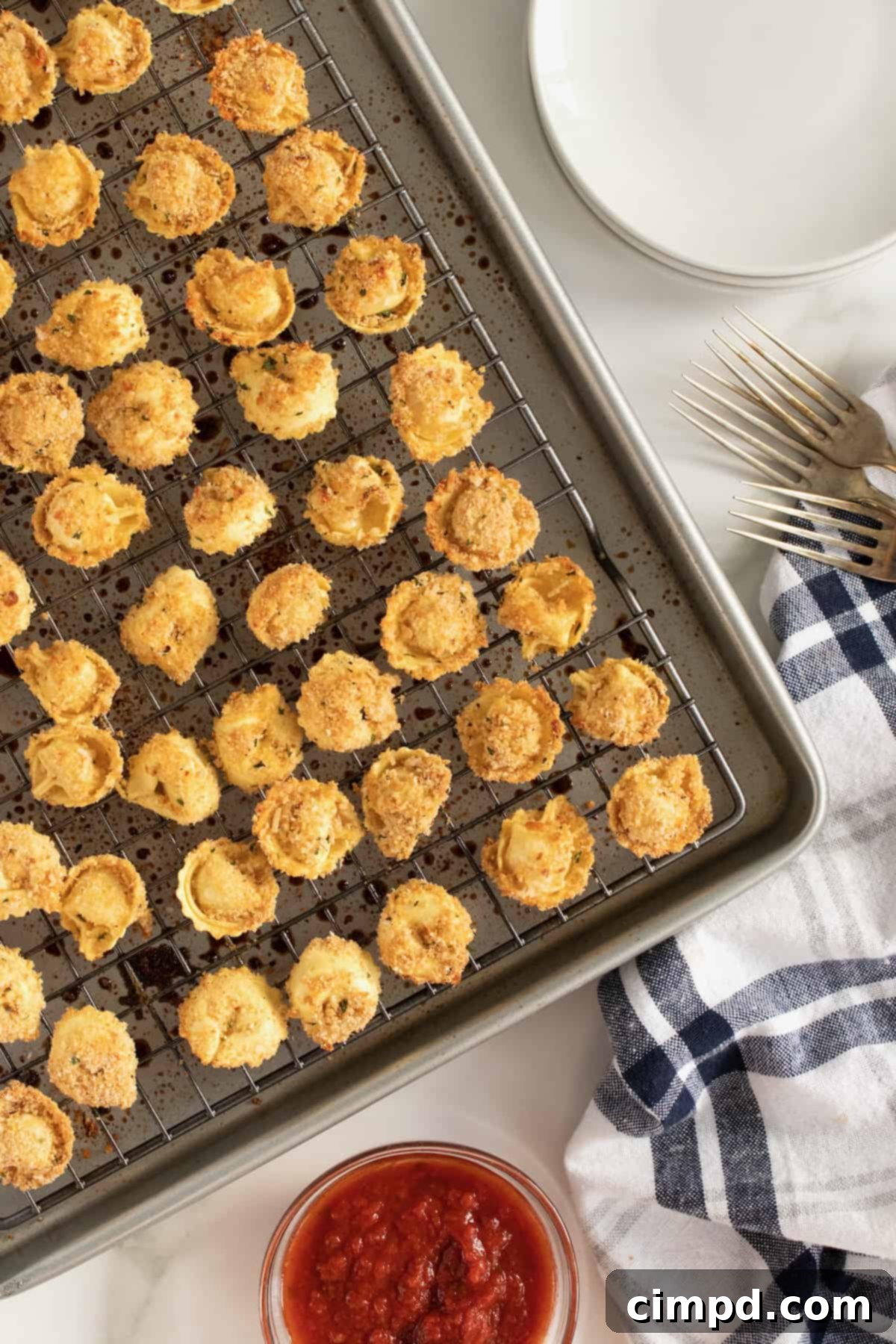 A bowl of Toasted Tortellini Bites with fresh basil garnish