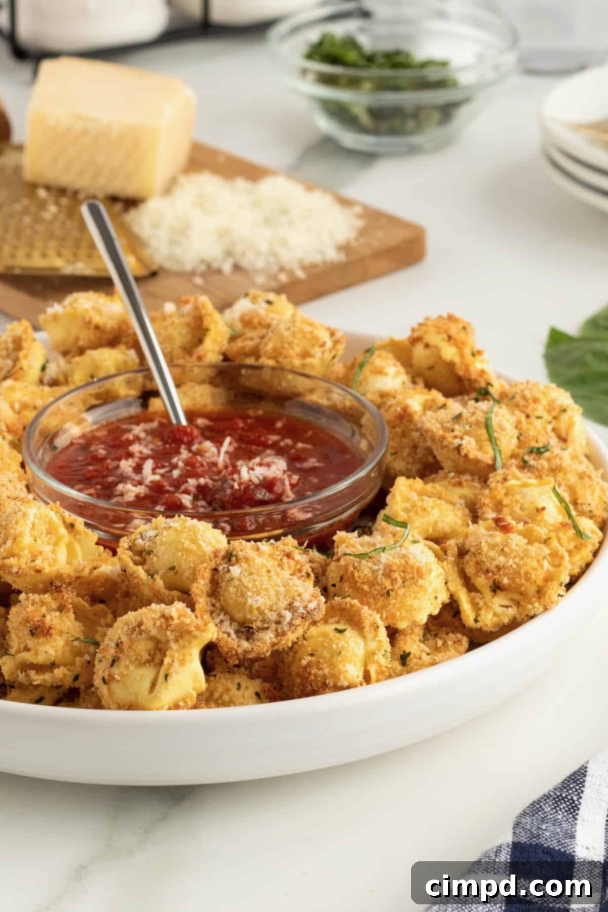 Assortment of appetizers including Toasted Tortellini Bites on a large platter