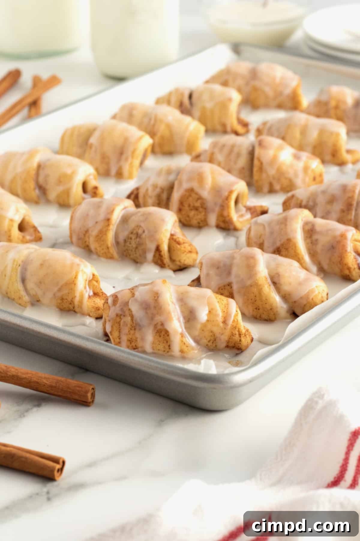 A close-up of a single Cinnamon Roll Pig in a Blanket, showcasing the wrapped sausage.
