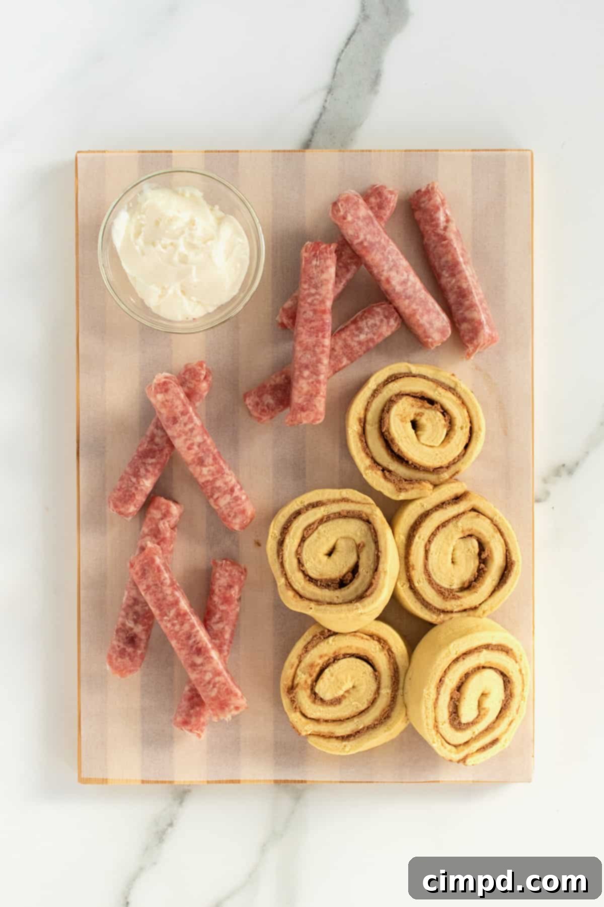 Cinnamon Glazed Sausage Rolls 6 Ingredients for Cinnamon Roll Pigs in a Blanket: canned jumbo cinnamon rolls and uncooked sausage links.