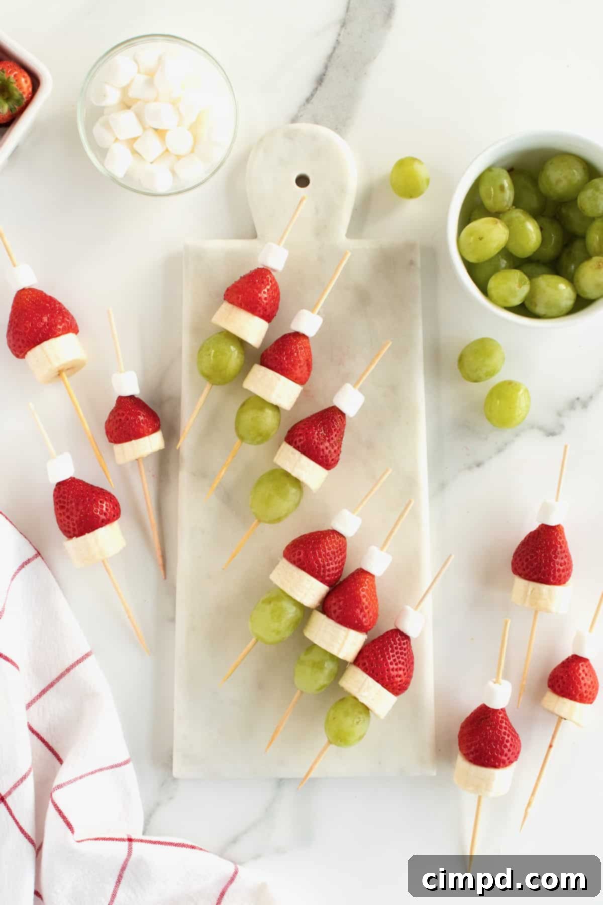 A platter of beautifully arranged Grinch Fruit Skewers, showcasing the finished product ready for serving at a holiday event.