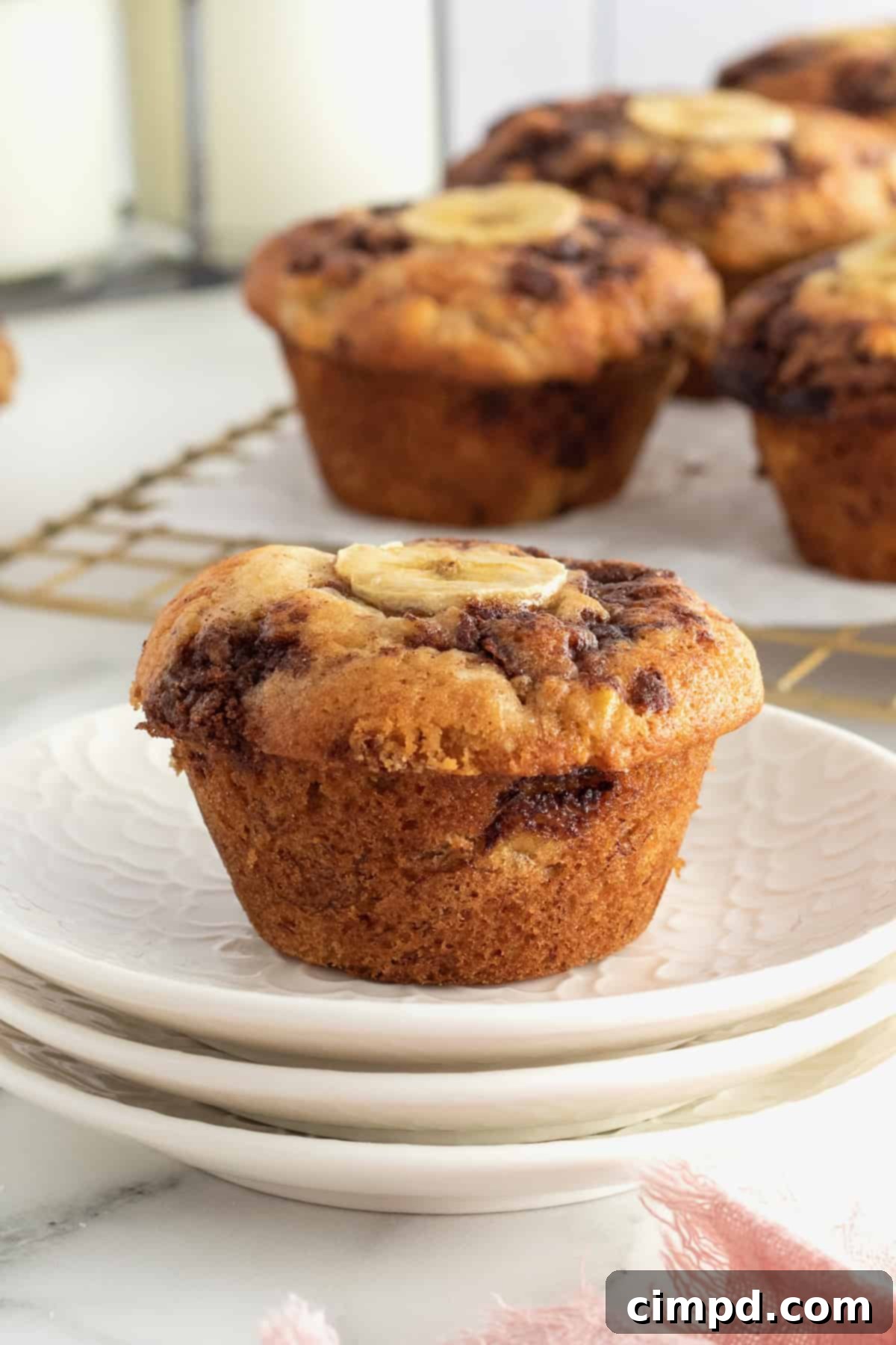 Freshly baked Cinnamon Swirled Banana Muffins on a cooling rack