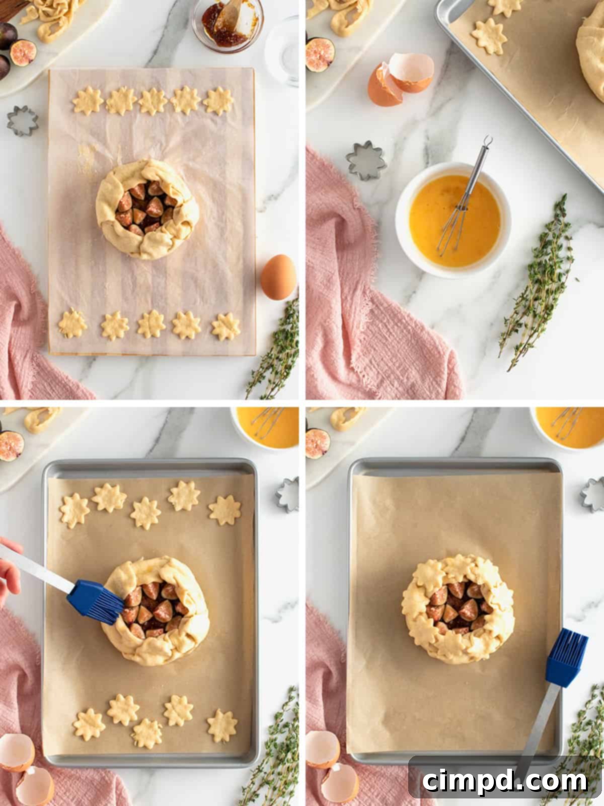 Wrapped brie with egg wash and decorative cut-outs on a parchment-lined baking sheet, ready for the oven.