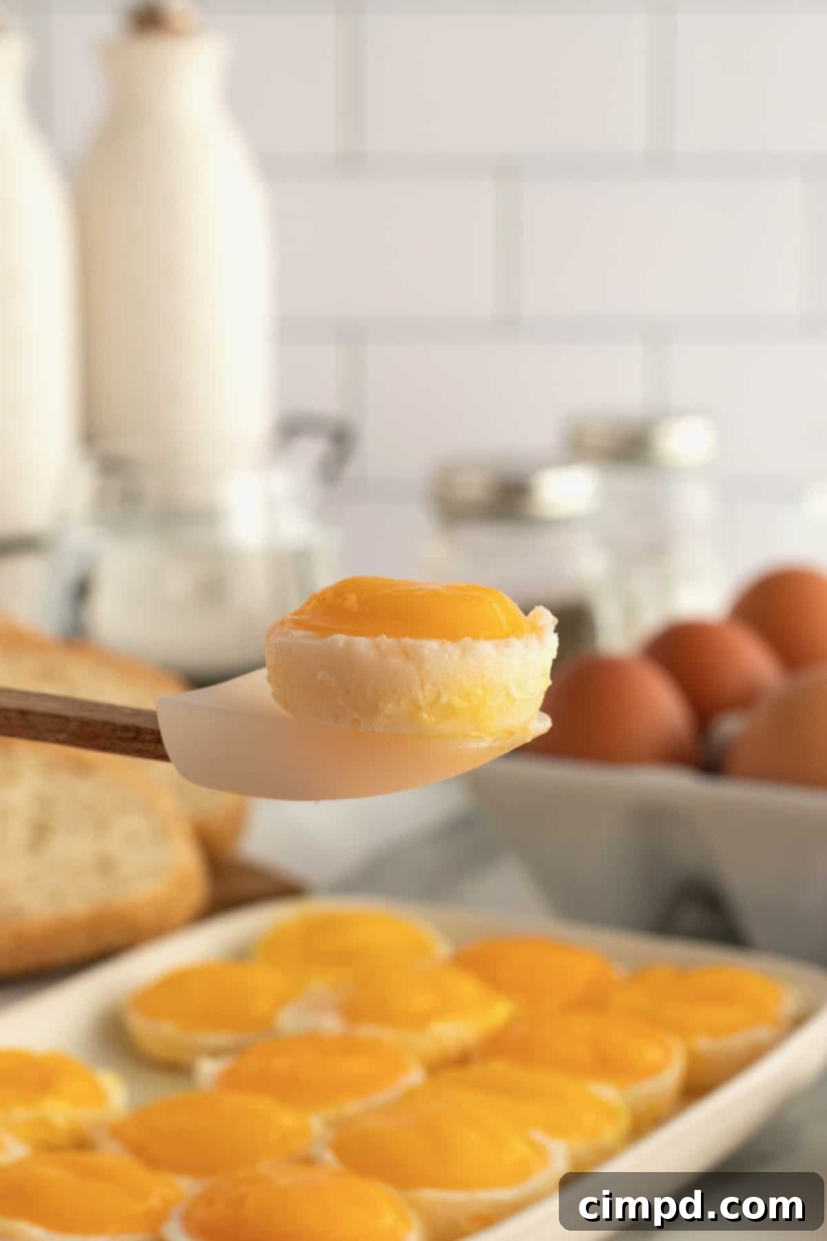 Bake Perfect Runny Eggs in Your Mini Muffin Pan 8 Freshly baked runny eggs in a muffin tin, with perfectly set whites and golden yolks, by The BakerMama
