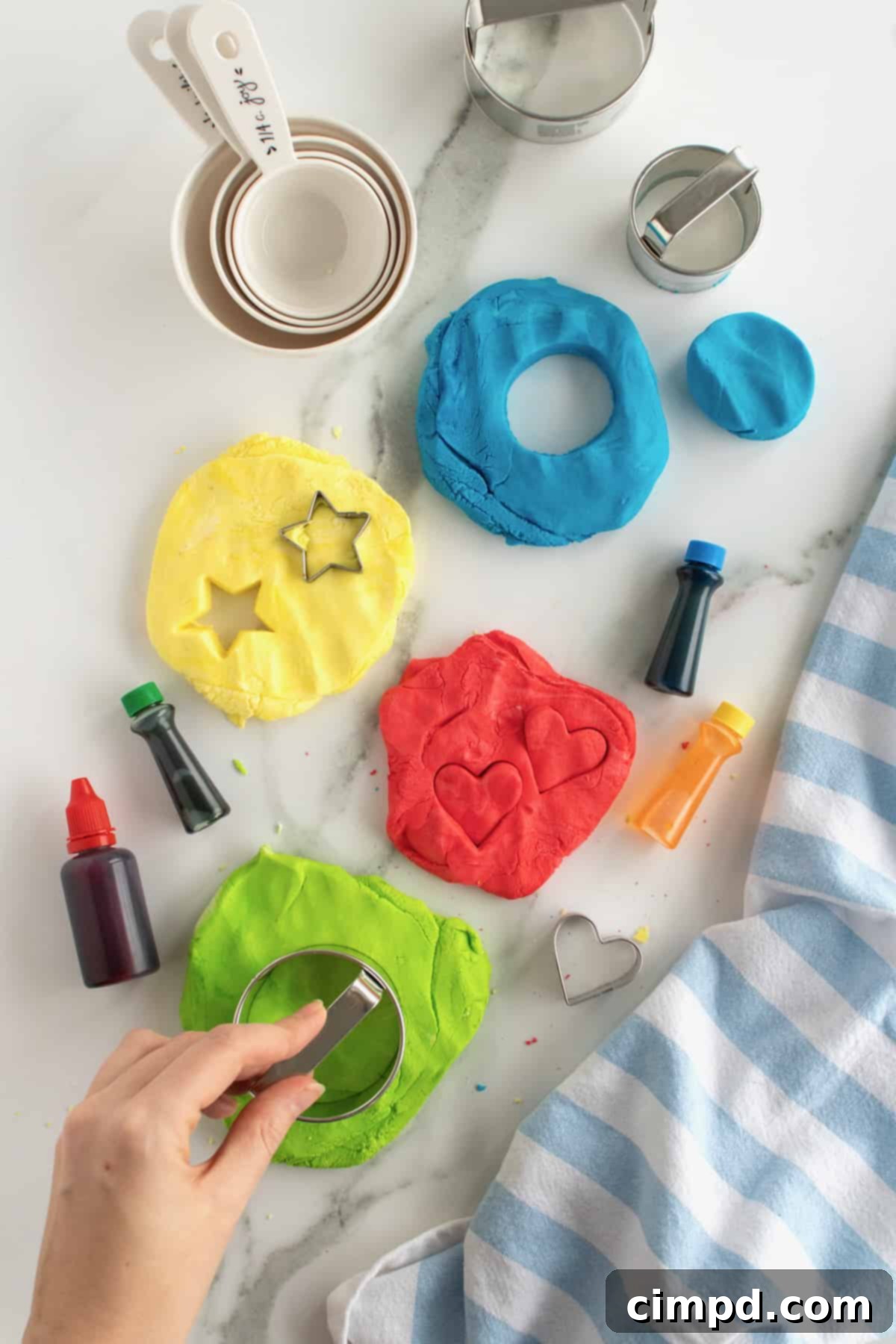Child's hands playing with vibrant edible play dough