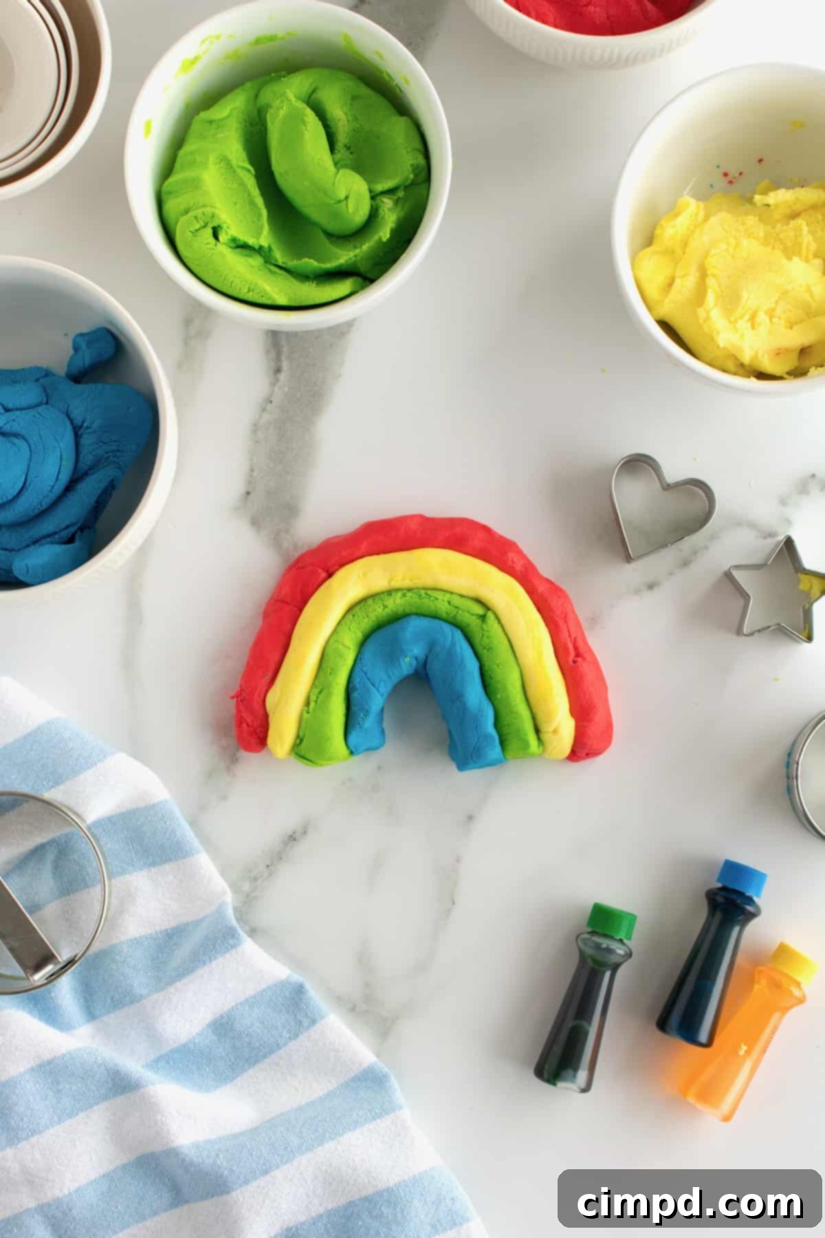 Edible play dough in various colors, shaped with cookie cutters