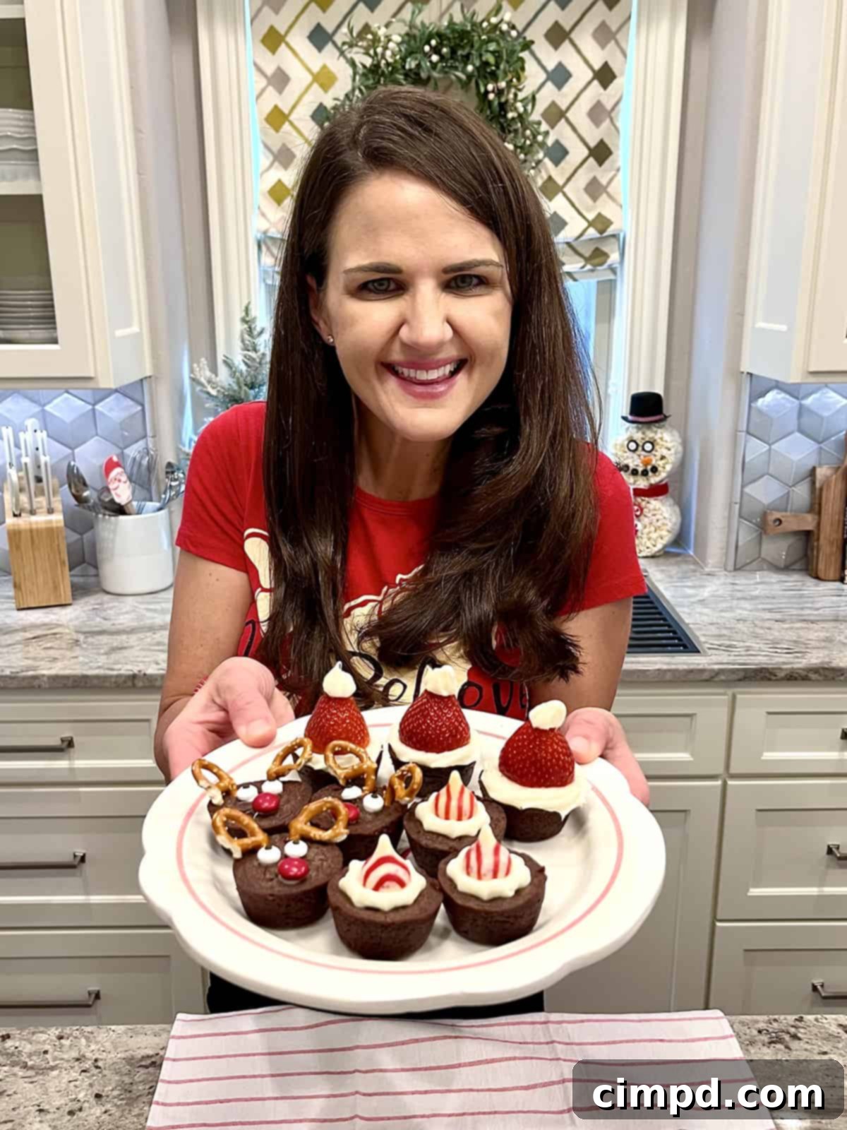 Festive Fudgy Bites 3 Smiling BakerMama holding a platter of Holiday Brownie Bites