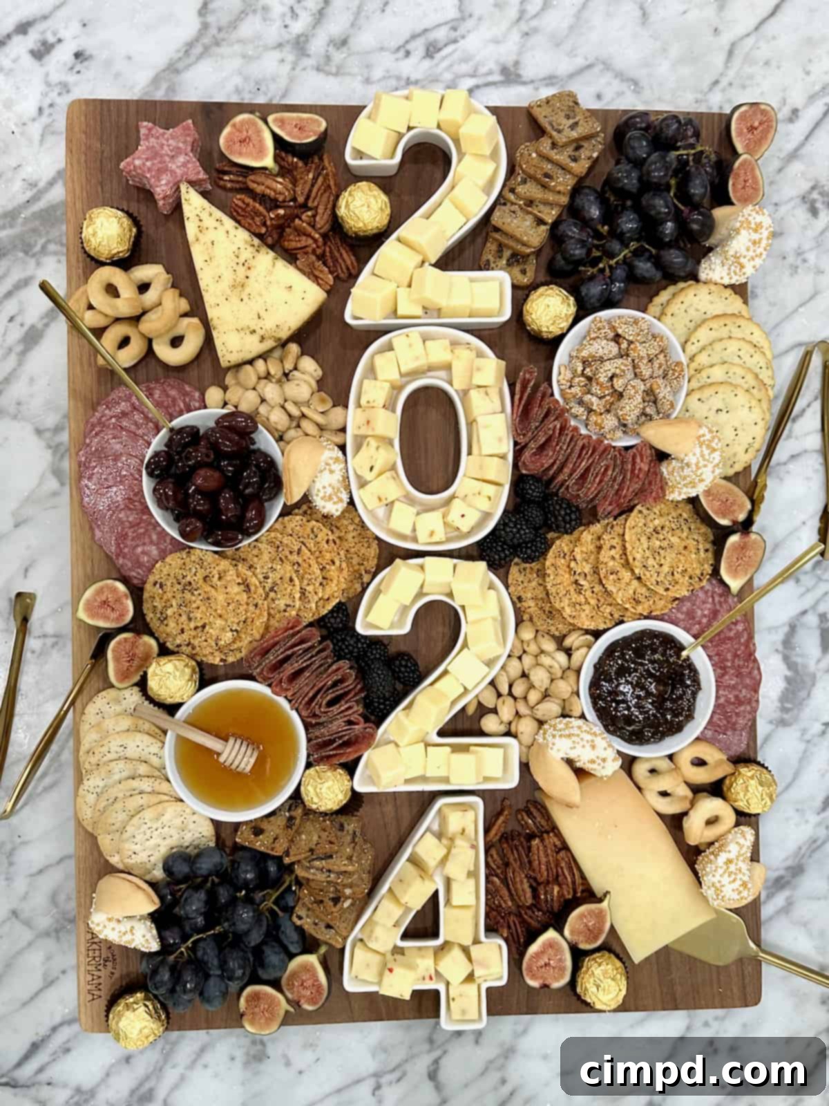 Gourmet NYE Cheese Spread 2 A large wood cheese board with 2024 spelled out in number dishes full of cheese cubes.