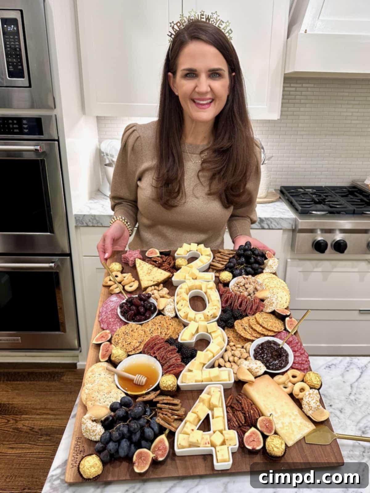Gourmet NYE Cheese Spread 3 A large wood cheese board with 2024 spelled out in number dishes full of white cheese cubes.