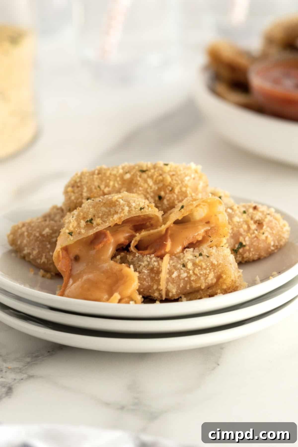 Unfolded wonton wrappers with scoops of pepperoni and cheese filling ready for folding.