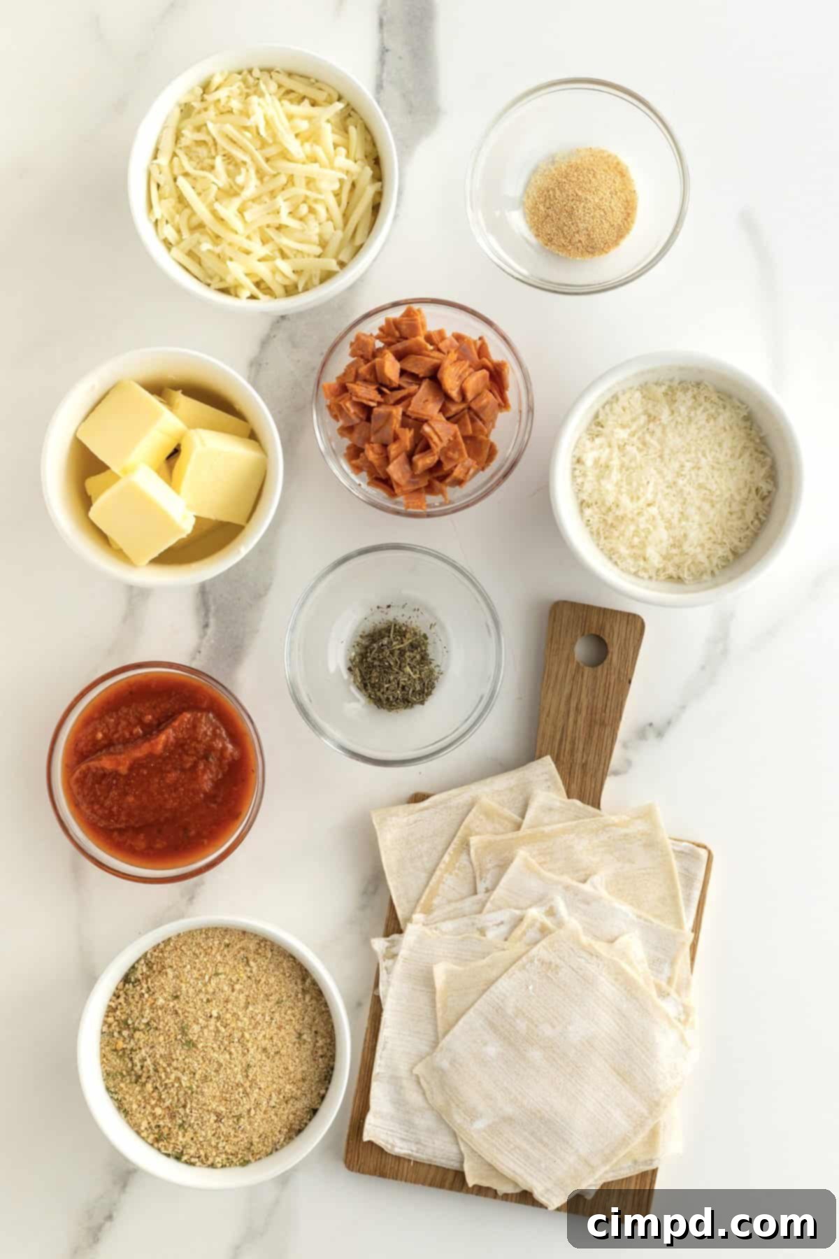 Bowl of pepperoni and cheese filling, melted butter, and breadcrumb mixture laid out for assembly.