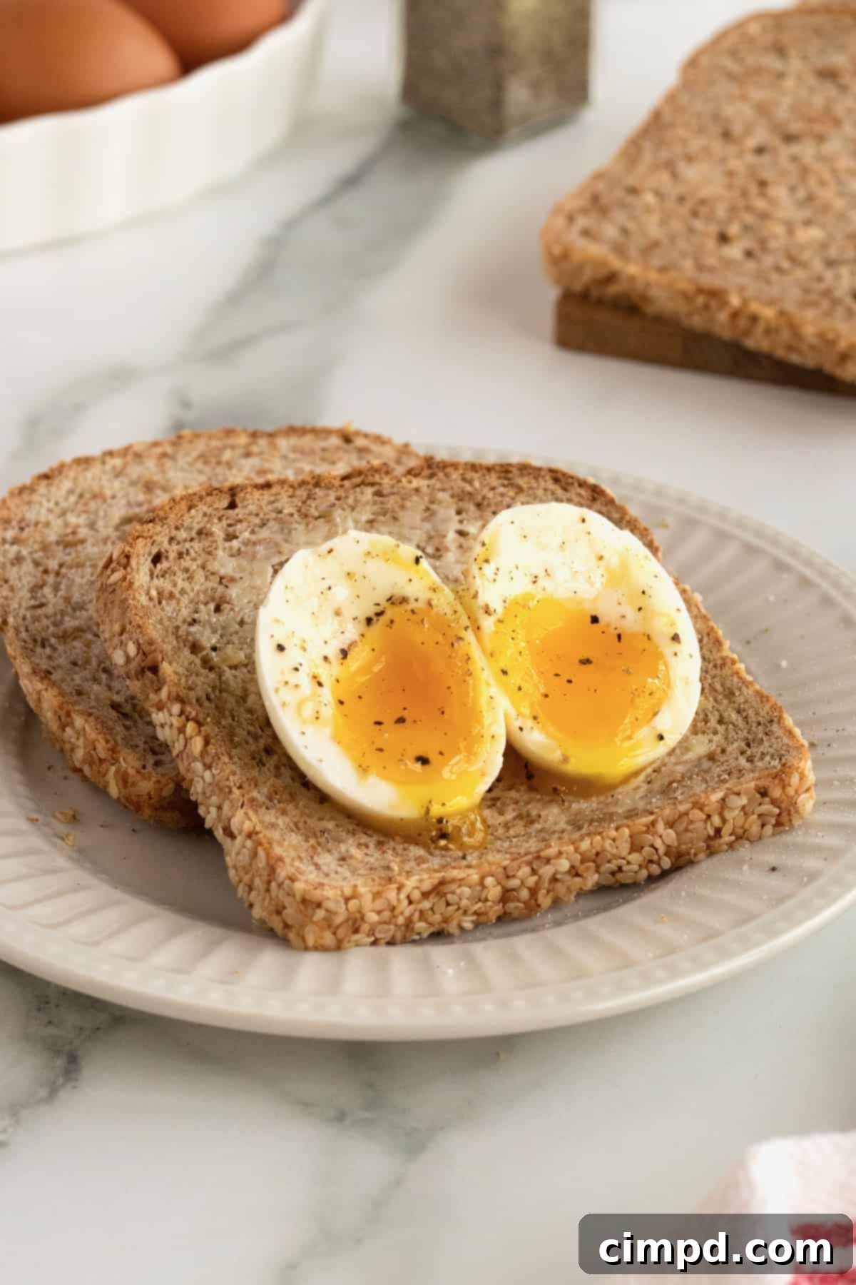 Close-up of a perfectly soft-boiled egg by The BakerMama with a runny yolk