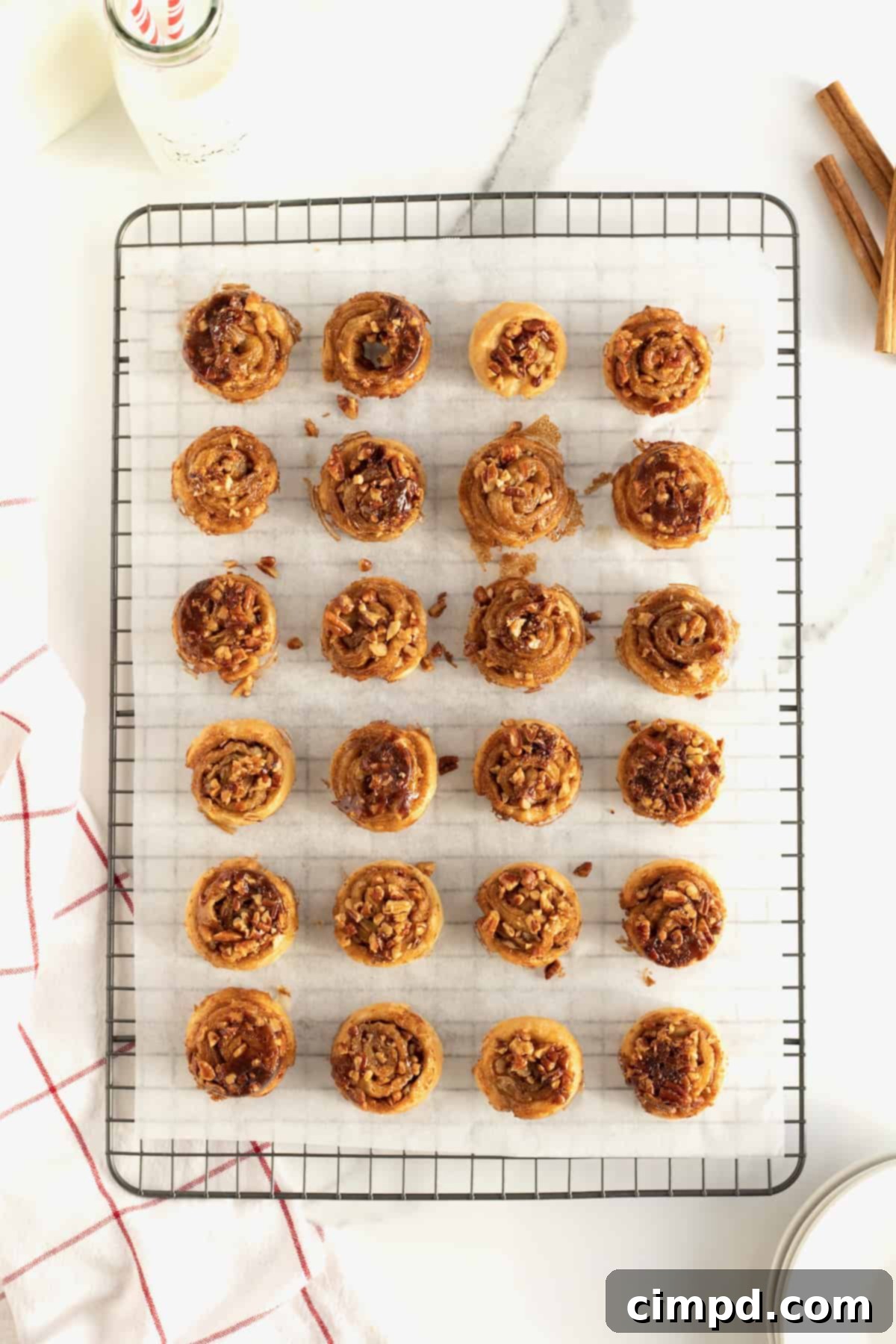 Gooey Sticky Bun Bites 8 Freshly baked Sticky Bun Bites inverted onto parchment paper with sticky glaze