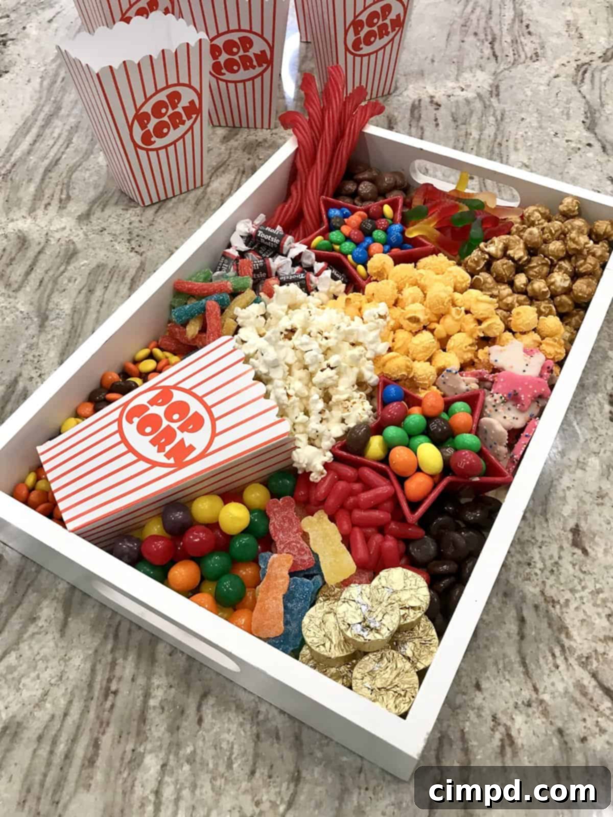 Assembled movie night popcorn and candy board