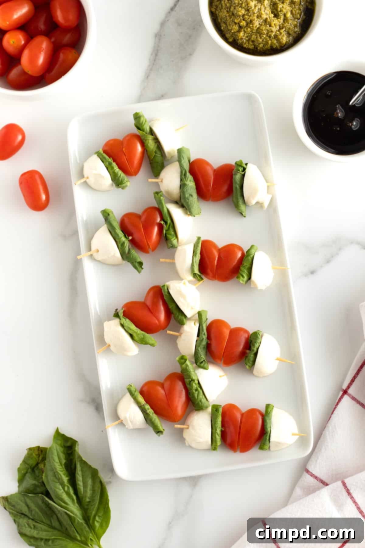 Close-up of heart-shaped Cupid's Caprese Skewers with tomatoes, mozzarella, and basil