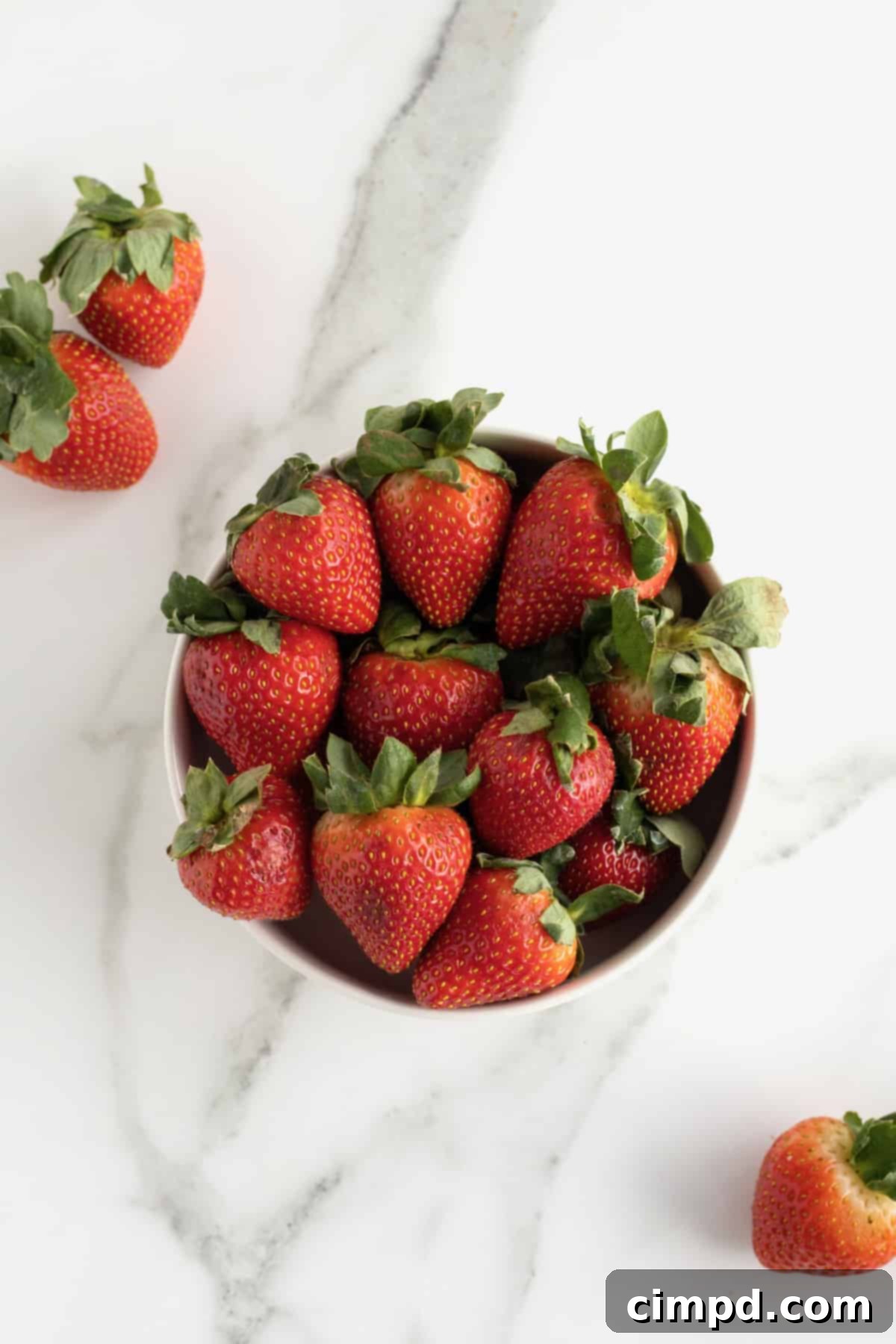 Making Perfect Strawberry Hearts 4 Key tools for making heart-shaped strawberries: a sharp paring knife, a cutting board, and large, pointed fresh strawberries.