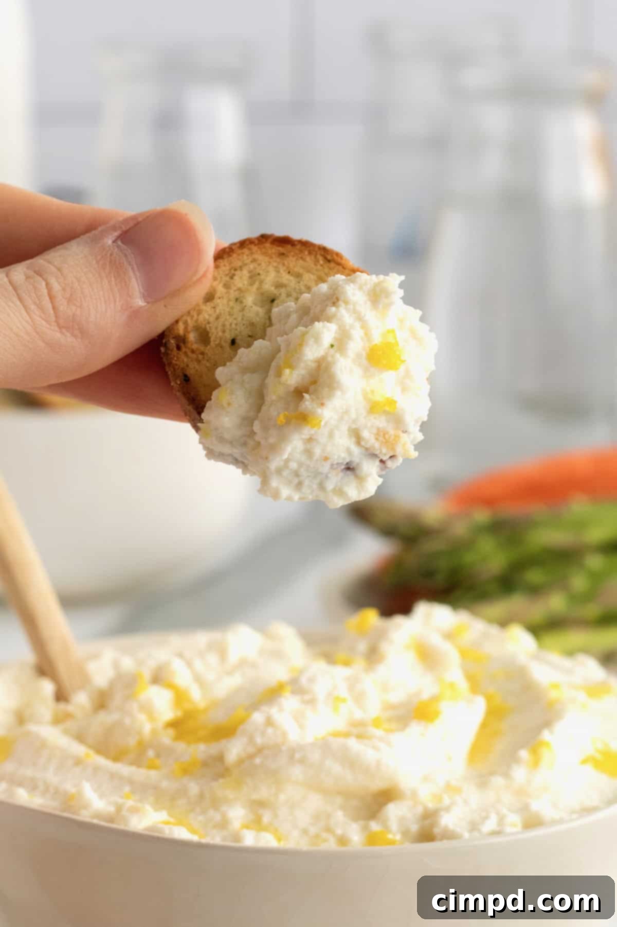 Close-up of fluffy whipped ricotta spread in a bowl, showing its creamy texture.