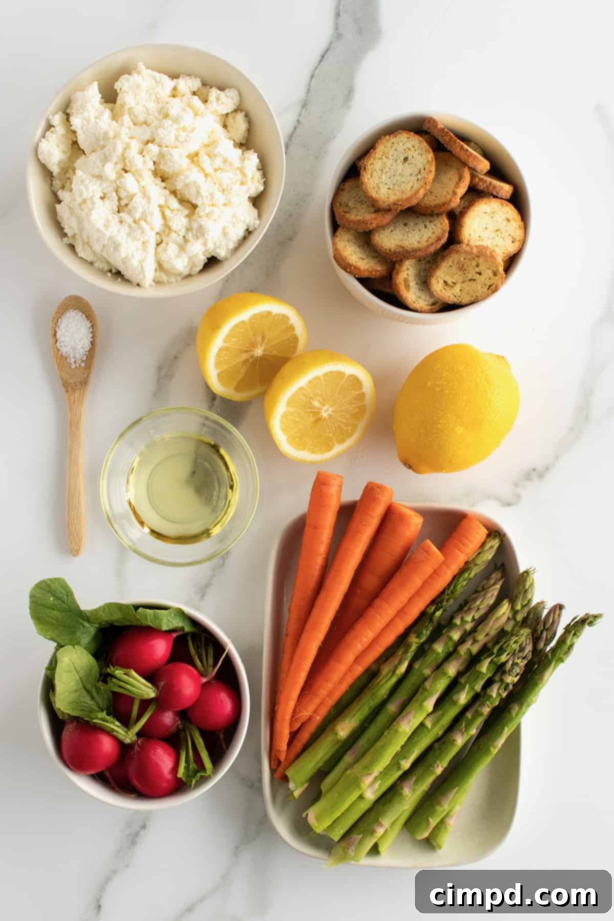 Ingredients for whipped ricotta spread laid out: ricotta cheese, a lemon, salt, and olive oil.
