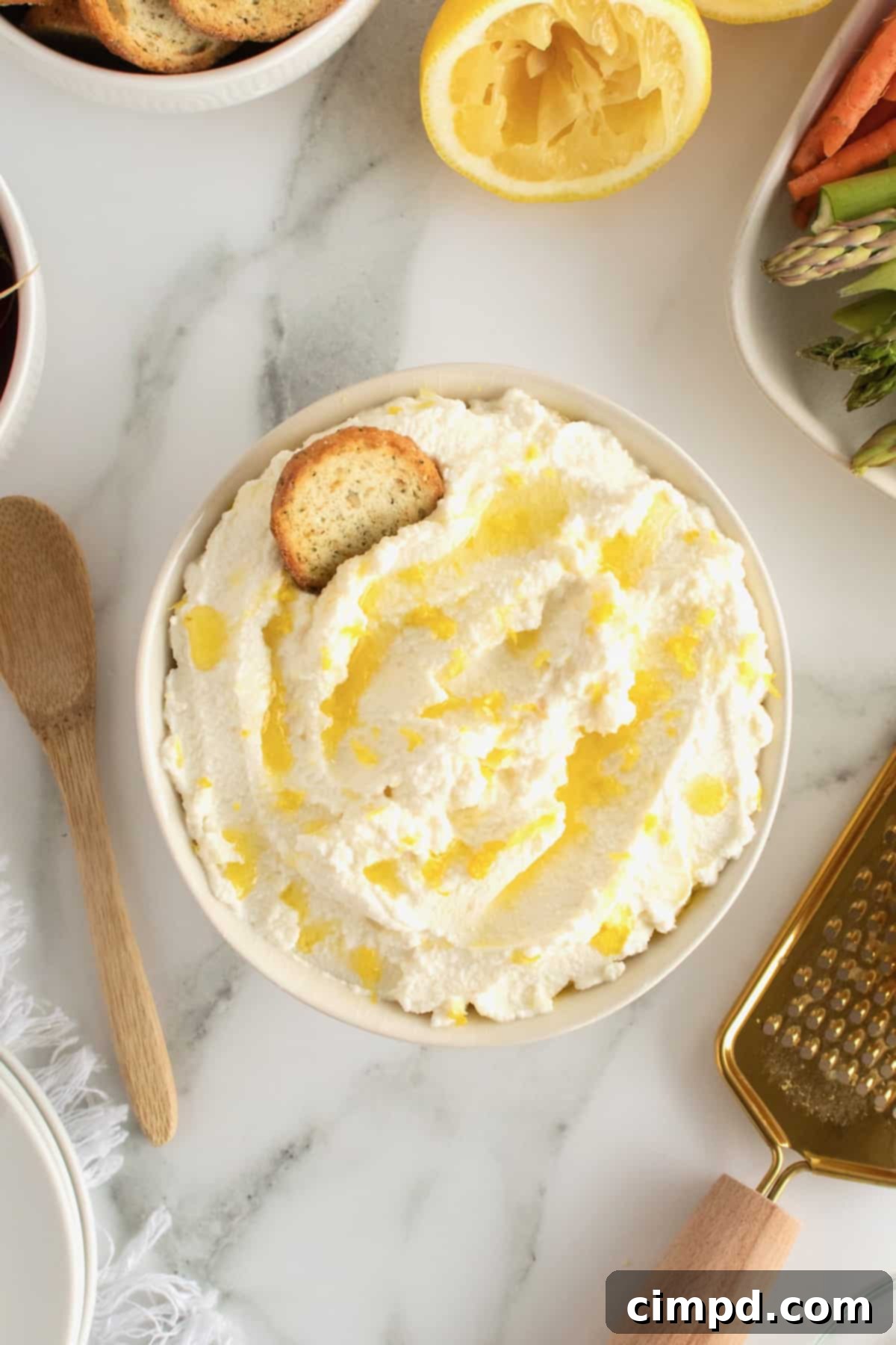 Served whipped ricotta spread with toasted bread slices and fresh vegetables for dipping.
