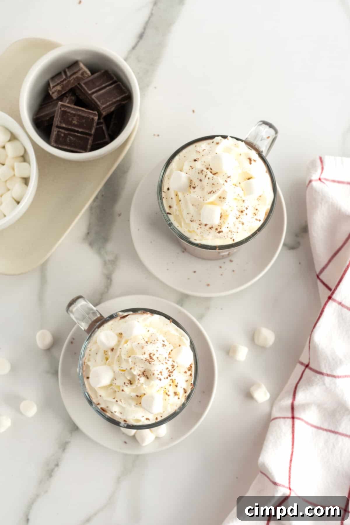 Pouring the rich, dark Homemade Hot Chocolate into a mug, showcasing its creamy texture.