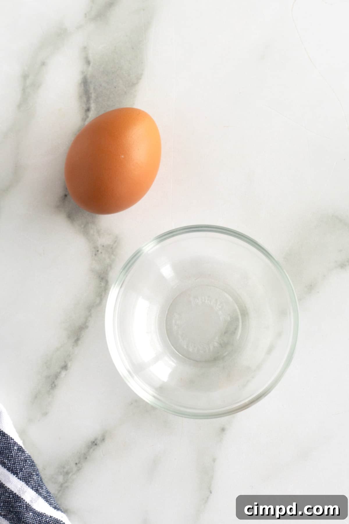 Essential ingredients for a perfect egg wash: a large egg and a tablespoon of water.