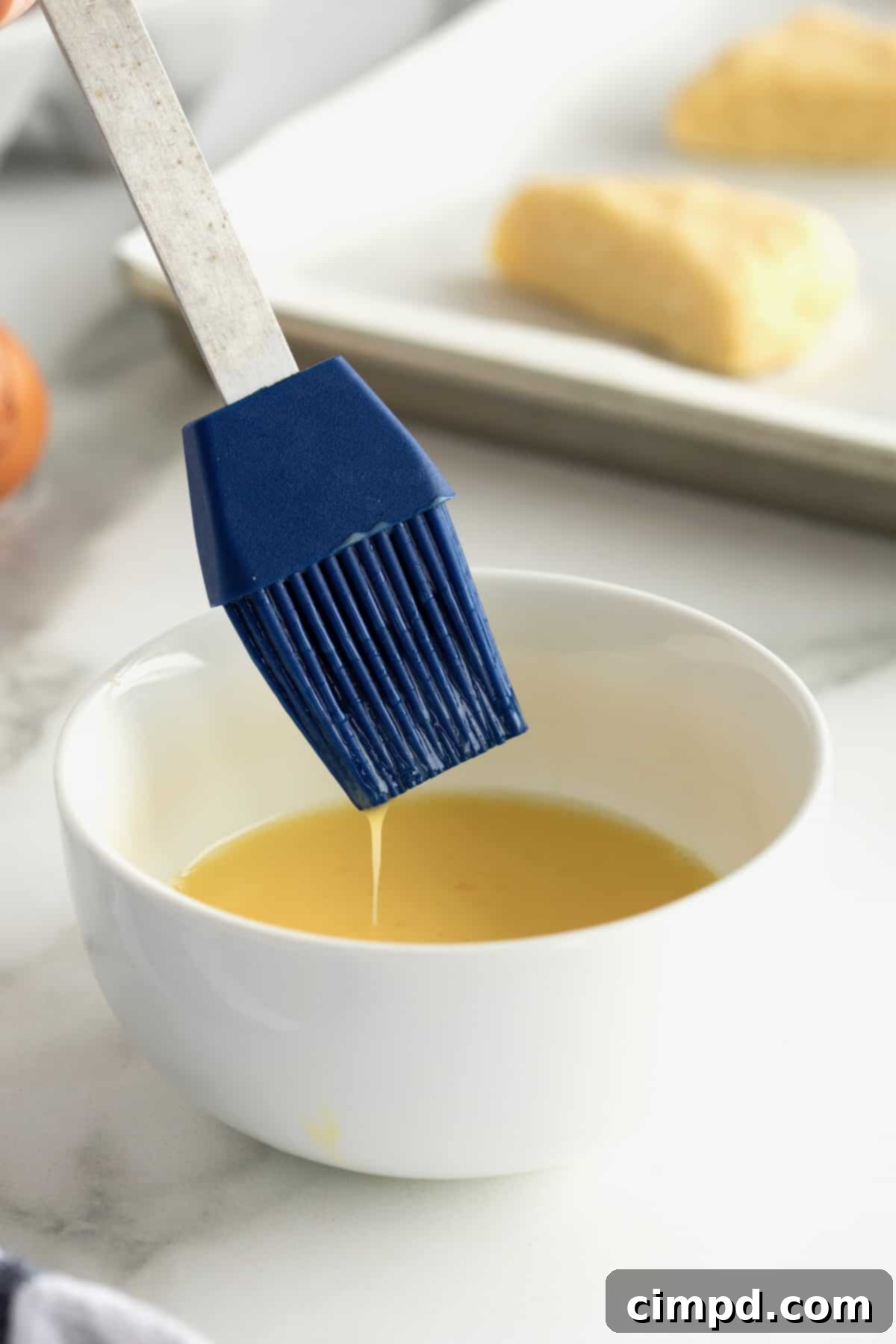 Various perfectly baked goods showcasing a brilliant golden and glossy finish from an egg wash.