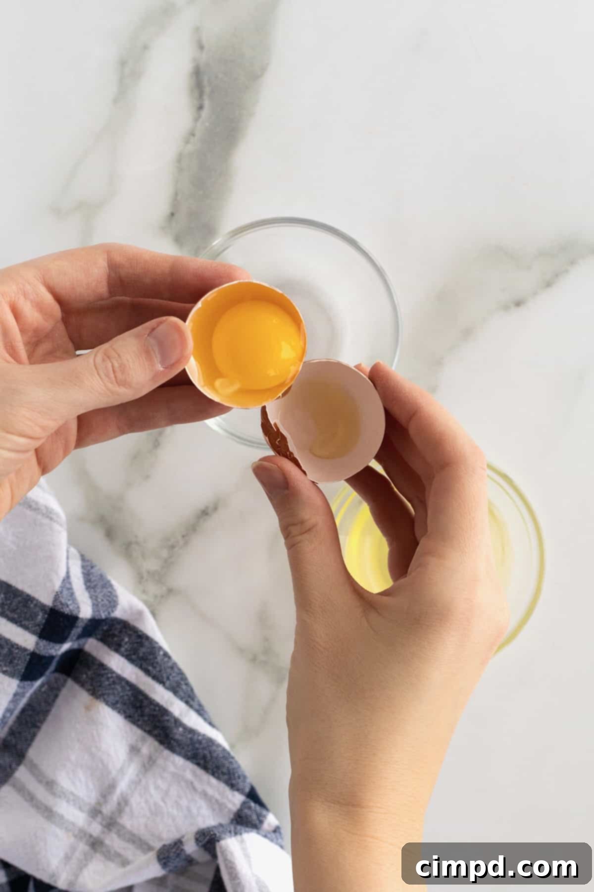 Flawless Egg Division 2 Learn how to expertly separate egg yolks from whites using an egg shell, a key skill for baking and cooking success, as demonstrated by The BakerMama.