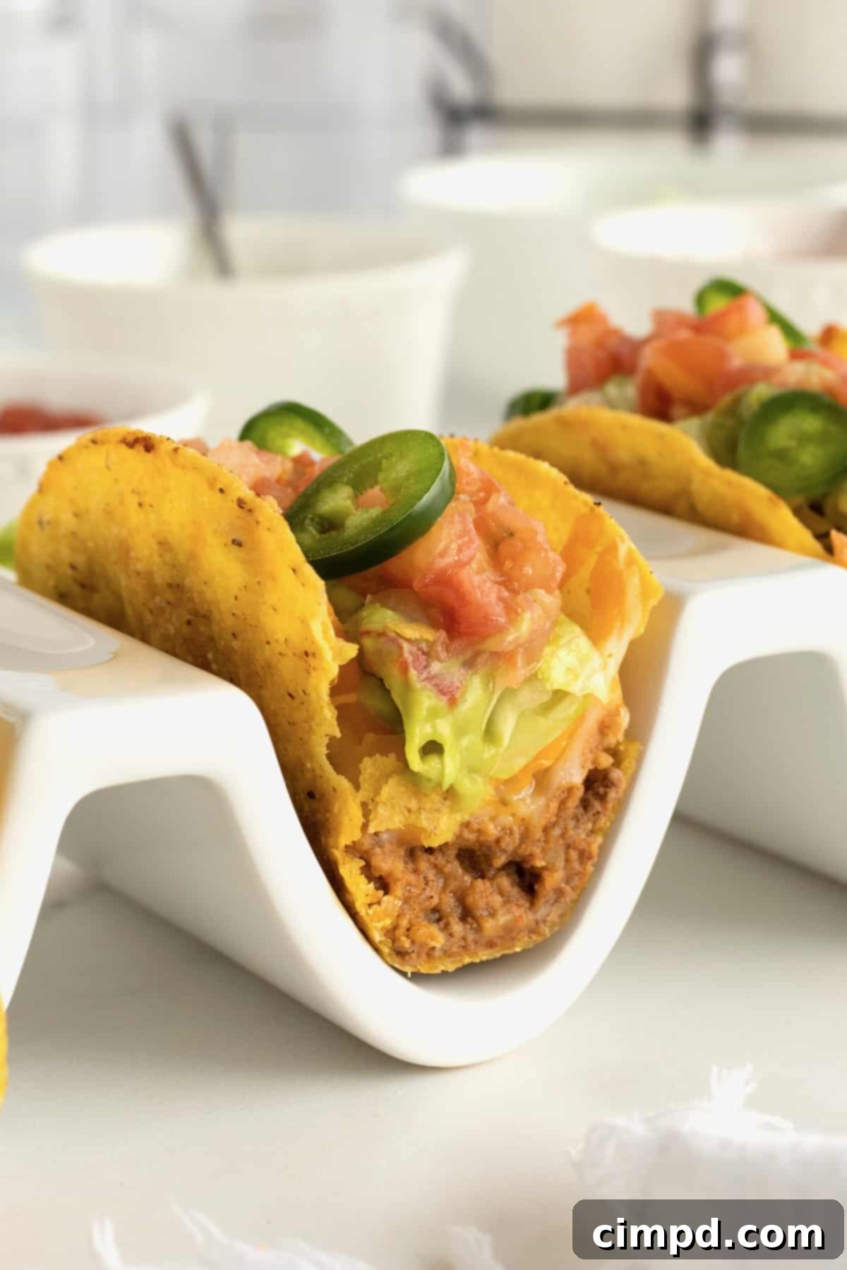 A vibrant table setting featuring Beef and Bean Baked Tacos with an array of fresh toppings and a festive atmosphere, by The BakerMama