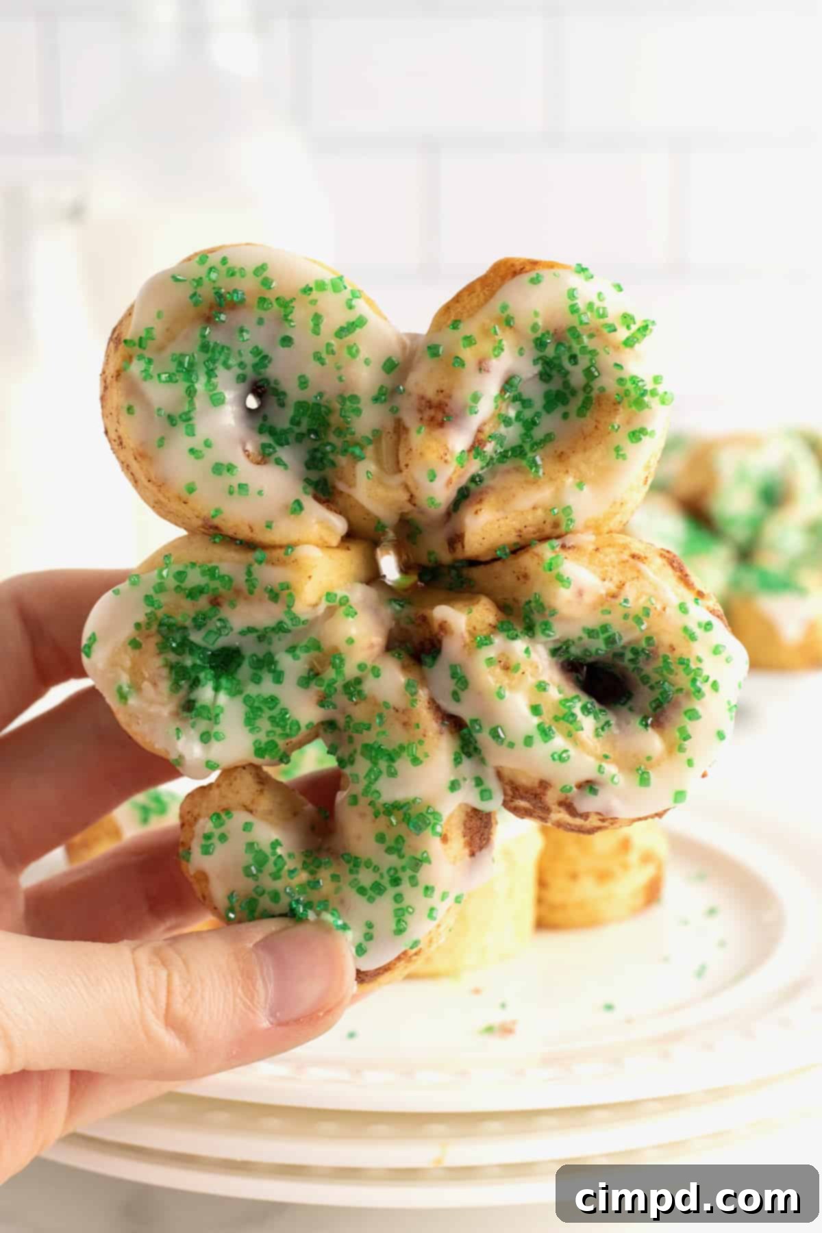 St. Patrick's Day Cinnamon Rolls neatly stacked on a plate, ready for storage or serving